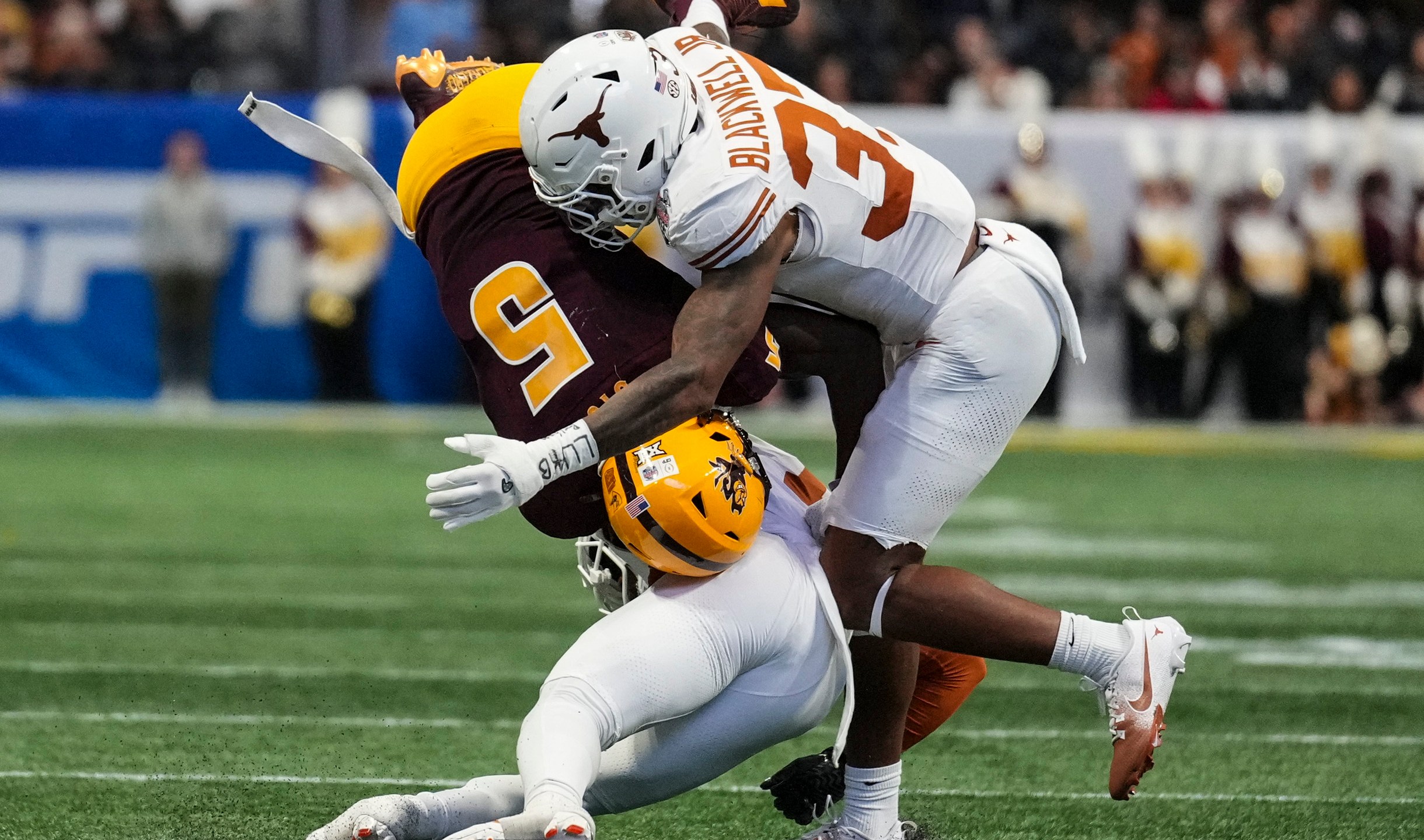 Texas linebacker Morice Blackwell Jr. (37) hits Arizona State wide receiver Melquan Stovall (5) during the first half in the quarterfinals of a College Football Playoff, Wednesday, Jan. 1, 2025, in Atlanta. (AP Photo/Brynn Anderson)