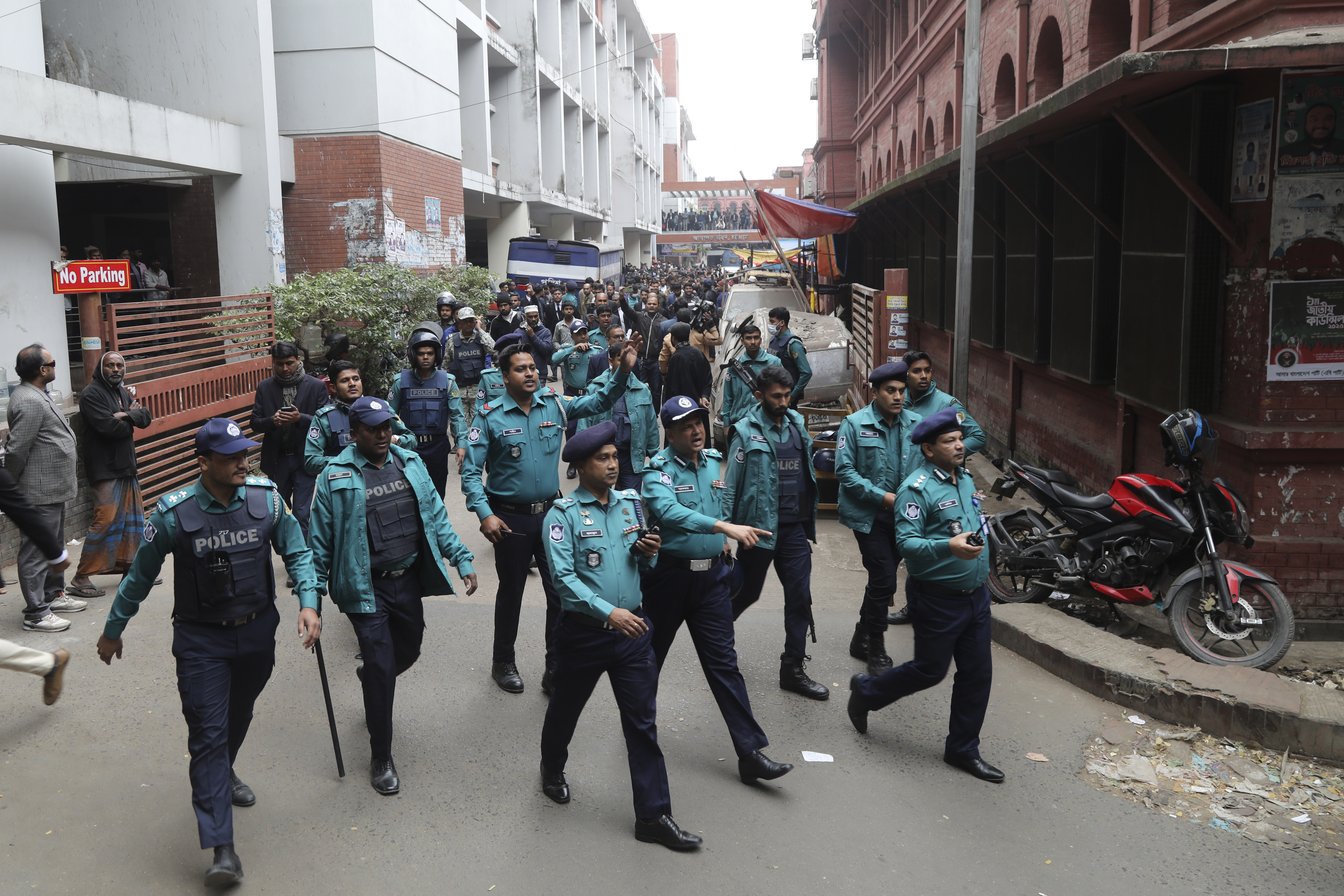 Police officials clear the way for the vehicle carrying Krishna Das Prabhu, a jailed Hindu leader, after a court rejected his plea for bail, in Chattogram, Bangladesh, Thursday, Jan. 2, 2025. (AP Photo)