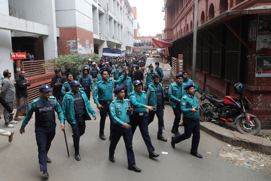 Police officials clear the way for the vehicle carrying Krishna Das Prabhu, a jailed Hindu leader, after a court rejected his plea for bail, in Chattogram, Bangladesh, Thursday, Jan. 2, 2025. (AP Photo)