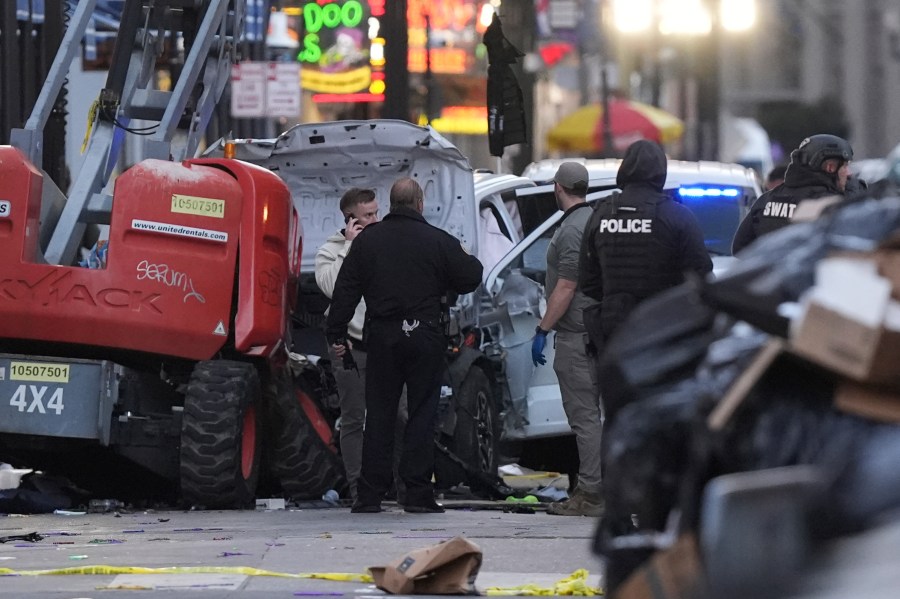 Emergency services attend the scene on Bourbon Street after a vehicle drove into a crowd on New Orleans' Canal and Bourbon Street, Wednesday Jan. 1, 2025. (AP Photo/Gerald Herbert)