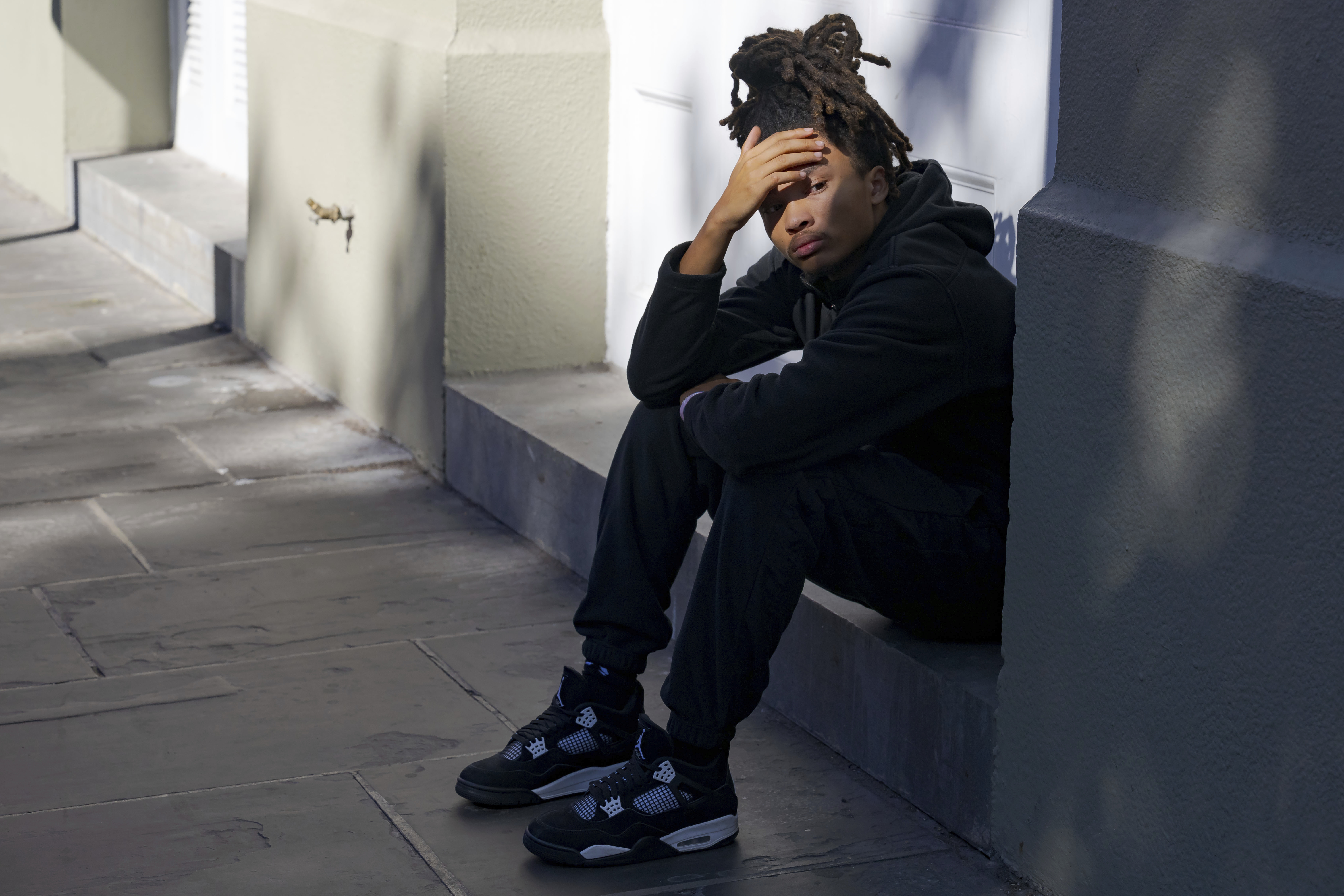 Trevant Hayes, 20, sits in the French Quarter after the death of his friend, Nikyra Dedeaux, 18, after a pickup truck crashed into pedestrians on Bourbon Street followed by a shooting in the French Quarter in New Orleans, Wednesday, Jan. 1, 2025. (AP Photo/Matthew Hinton)