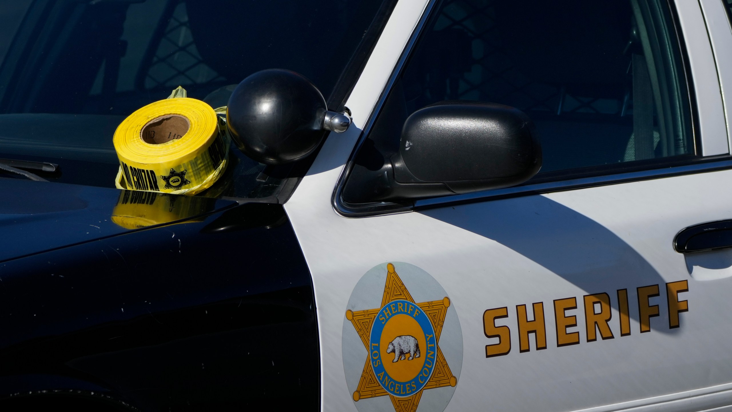 FILE - A roll of police tape is left on the windshield of a Los Angeles County sheriff's vehicle in the parking lot of its training academy in Whittier, Calif., Nov. 16, 2022. (AP Photo/Jae C. Hong, File)