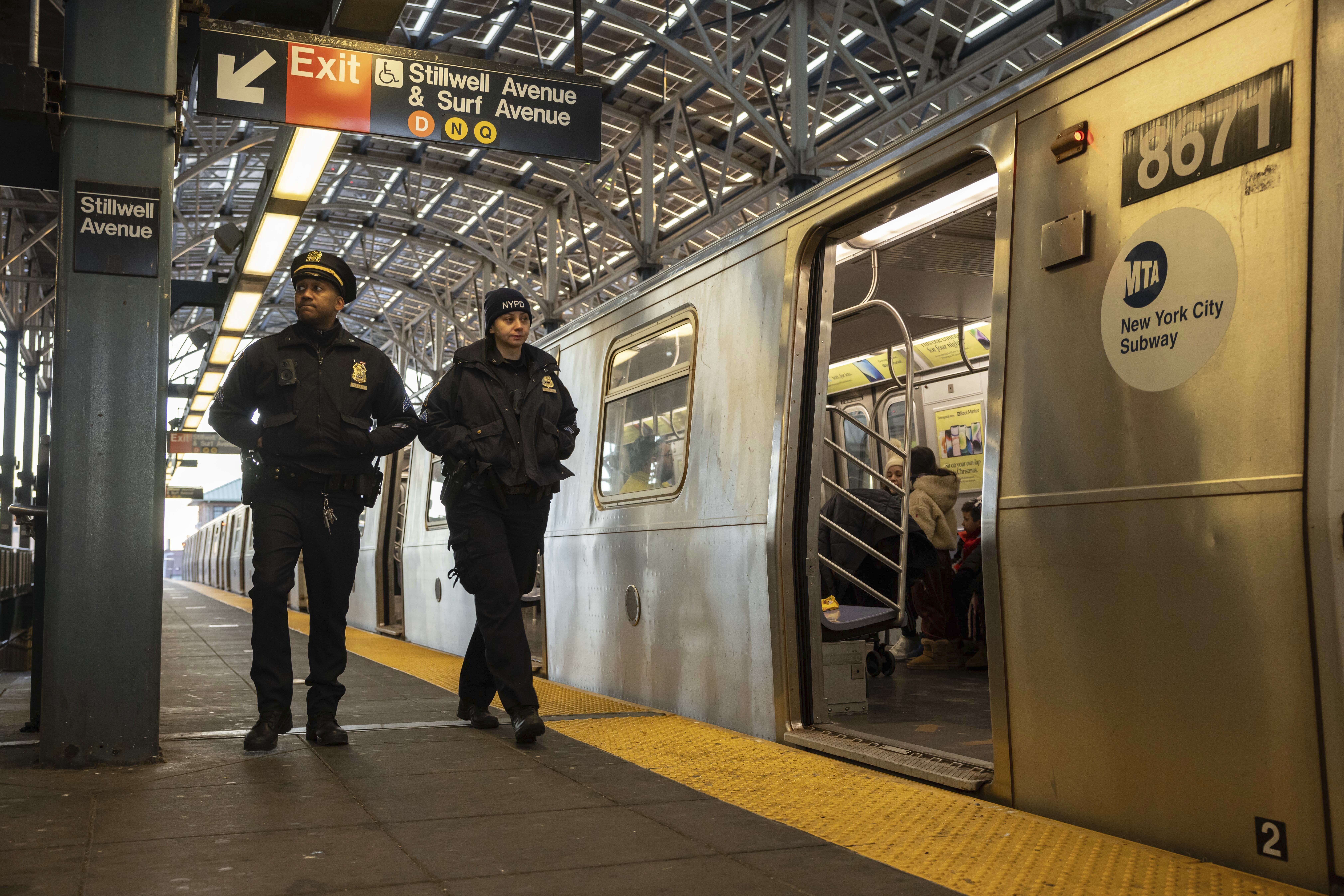 Police officers patrol the F train platform at the Coney Island-Stillwell Avenue Station, Thursday, Dec. 26, 2024, in New York. (AP Photo/Yuki Iwamura)