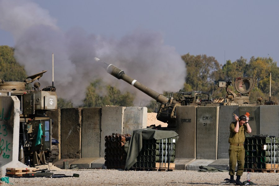 An Israeli soldier covers his ears as an artillery gunner fires into the Gaza Strip from a position in southern Israel, Thursday, Jan. 2, 2025.(AP Photo/Matias Delacroix)