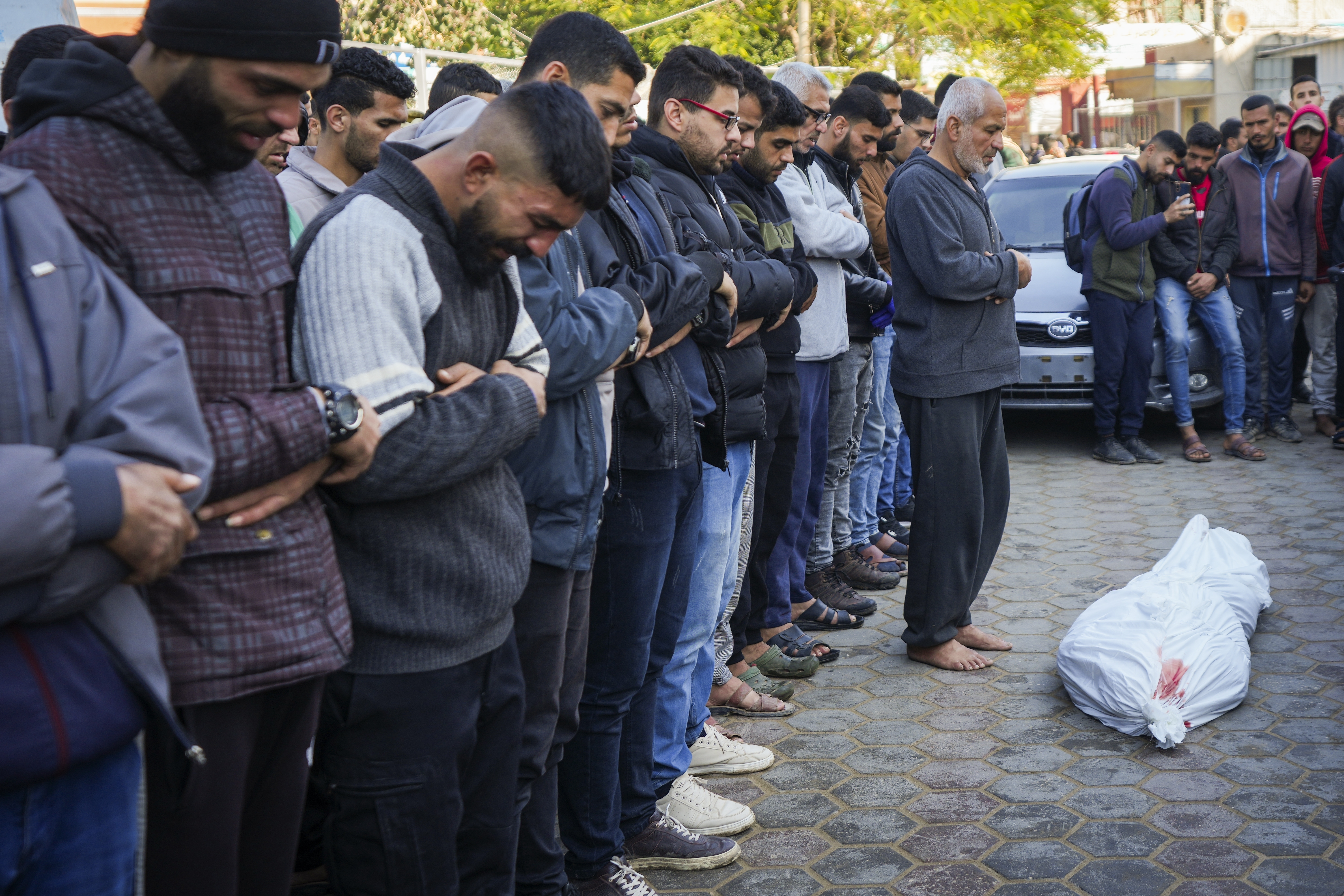 Palestinians pray over the body before the funeral of a man killed during an Israeli army strike in Deir al-Balah in the central Gaza Strip, Thursday Jan. 2, 2025.(AP Photo/Abdel Kareem Hana)