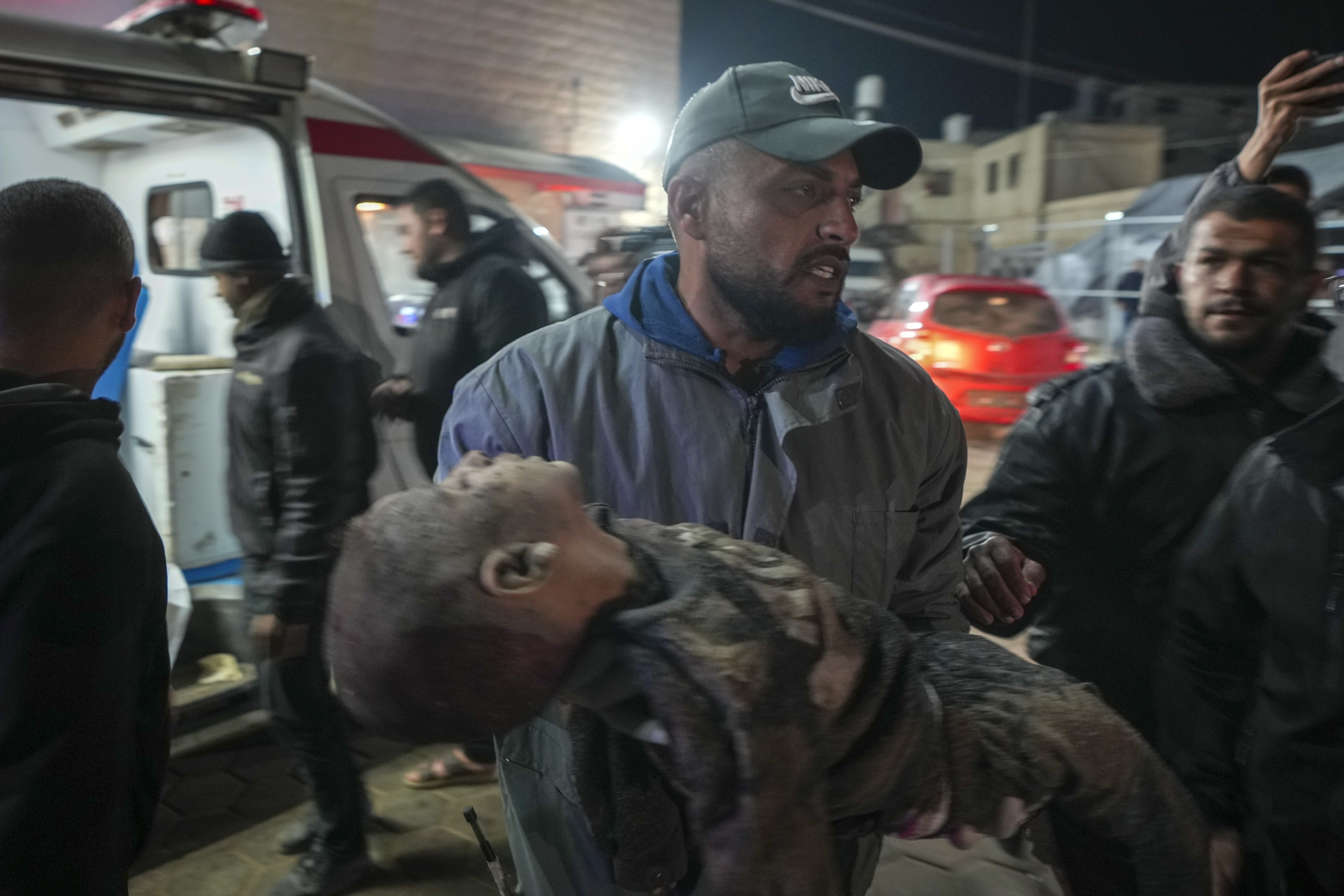 A dead child is brought to Al-Aqsa Martyrs Hospital after Israeli army airstrikes targeted the Nuseirat and Maghazi camps, in Deir al-Balah, central Gaza Strip, Thursday, Jan. 2, 2025. (AP Photo/Abdel Kareem Hana)