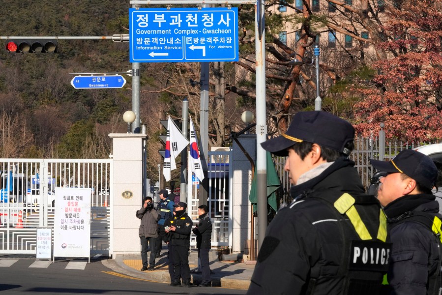 Police officers stand guard as they wait for the arrival of impeached South Korean President Yoon Suk Yeol near the Corruption Investigation Office for High-ranking Officials in Gwacheon, South Korea, Friday, Jan. 3, 2025. (AP Photo/Ahn Young-joon)