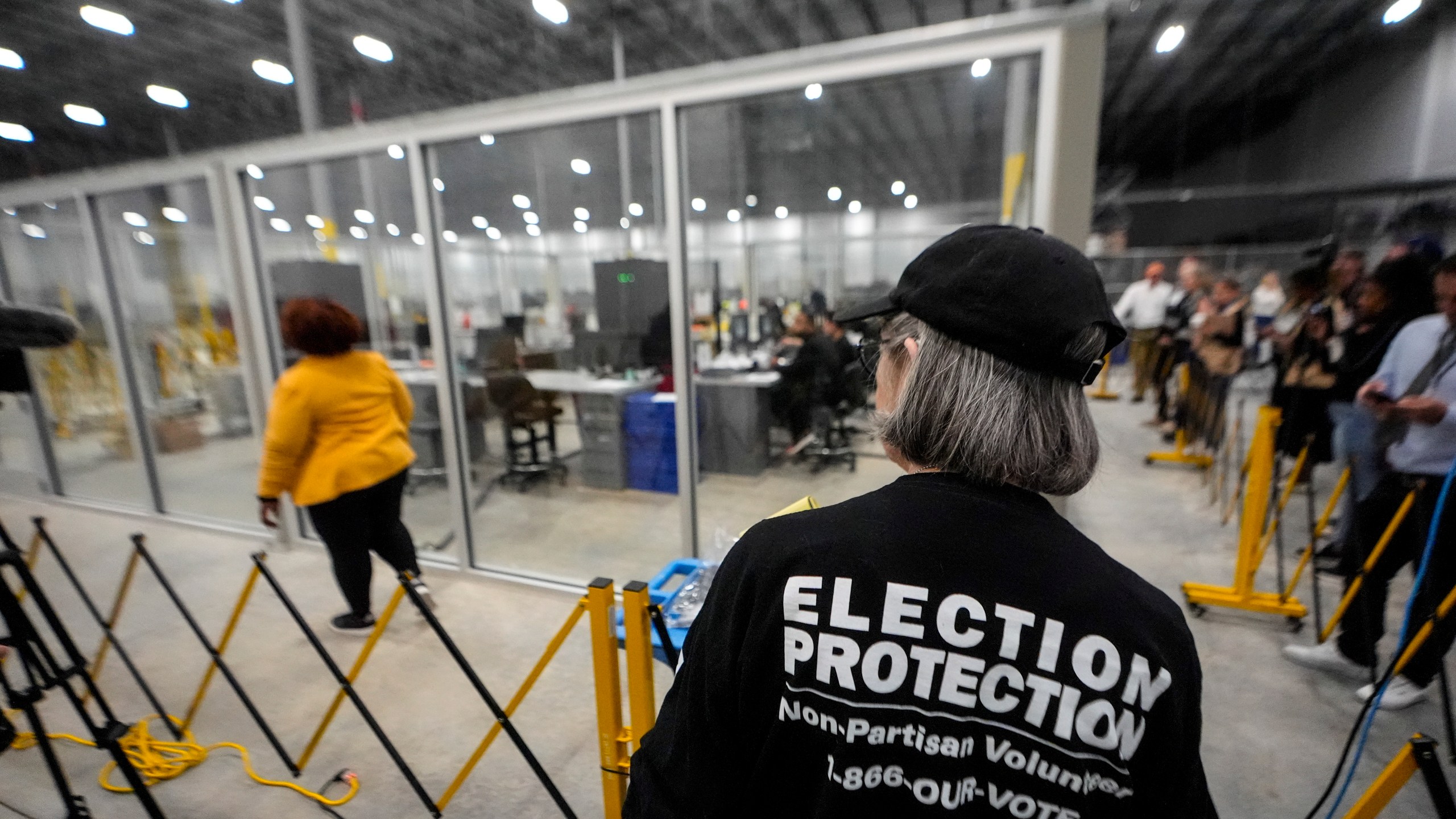 FILE - A non-partisan election volunteer observes as memory cards are uploaded from early voting at the Fulton County Election Hub and Operation Center, Nov. 5, 2024, in Atlanta, Mo. (AP Photo/John Bazemore, File)