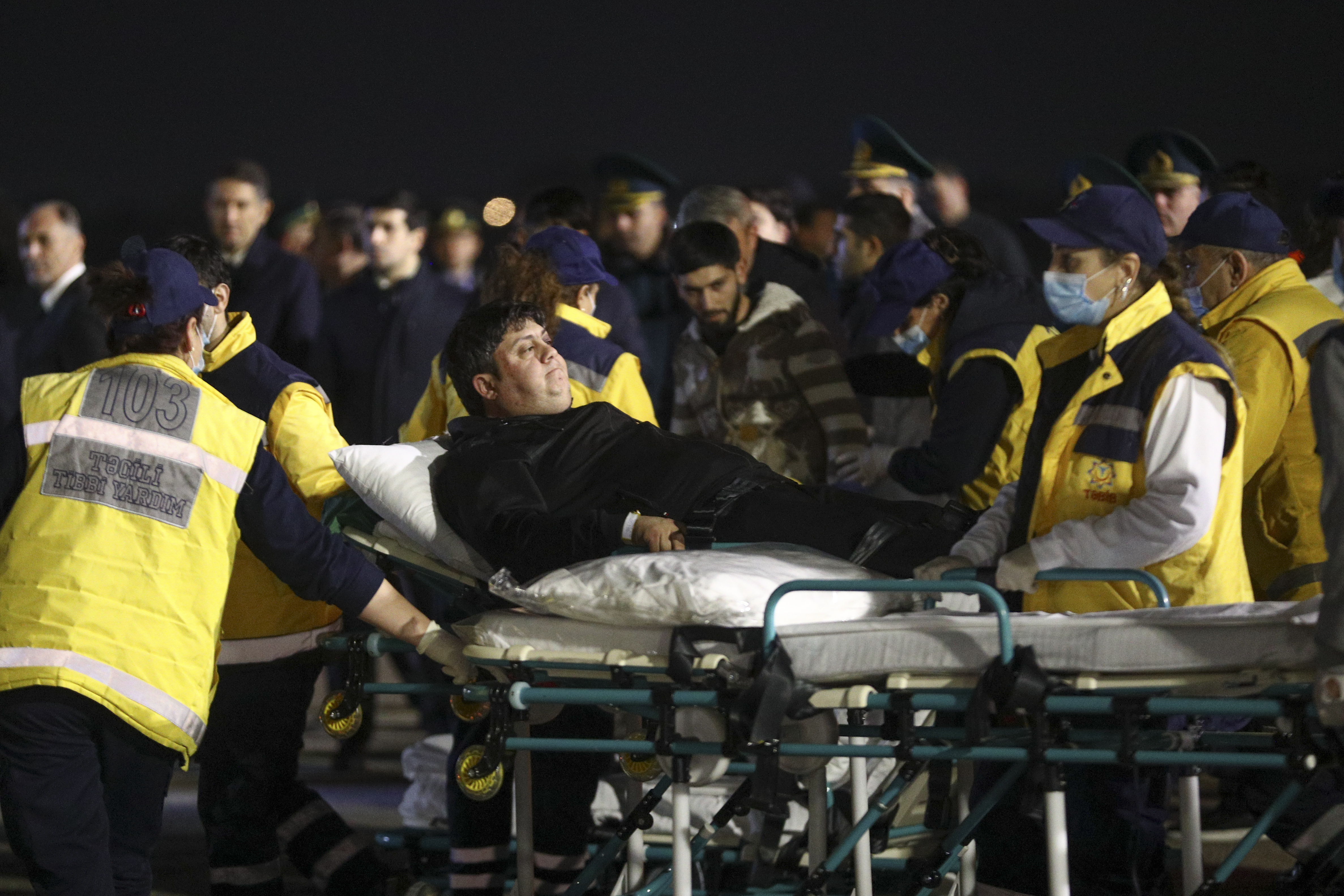 Wounded passengers of the Azerbaijani Airline's plane crashed near the Kazakhstani city of Aktau, are transported from a medical plane at the Heydar Aliyev International Airport outside Baku, Azerbaijan, Thursday, Dec. 26, 2024. (AP Photo)