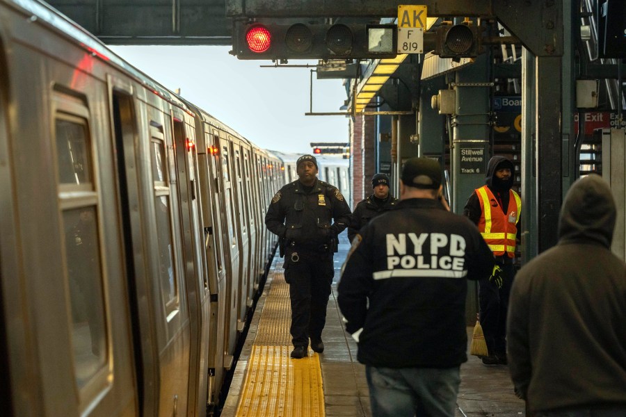 FILE - Police officers patrol the F train platform at the Coney Island-Stillwell Avenue Station, Thursday, Dec. 26, 2024, in New York. (AP Photo/Yuki Iwamura, File)