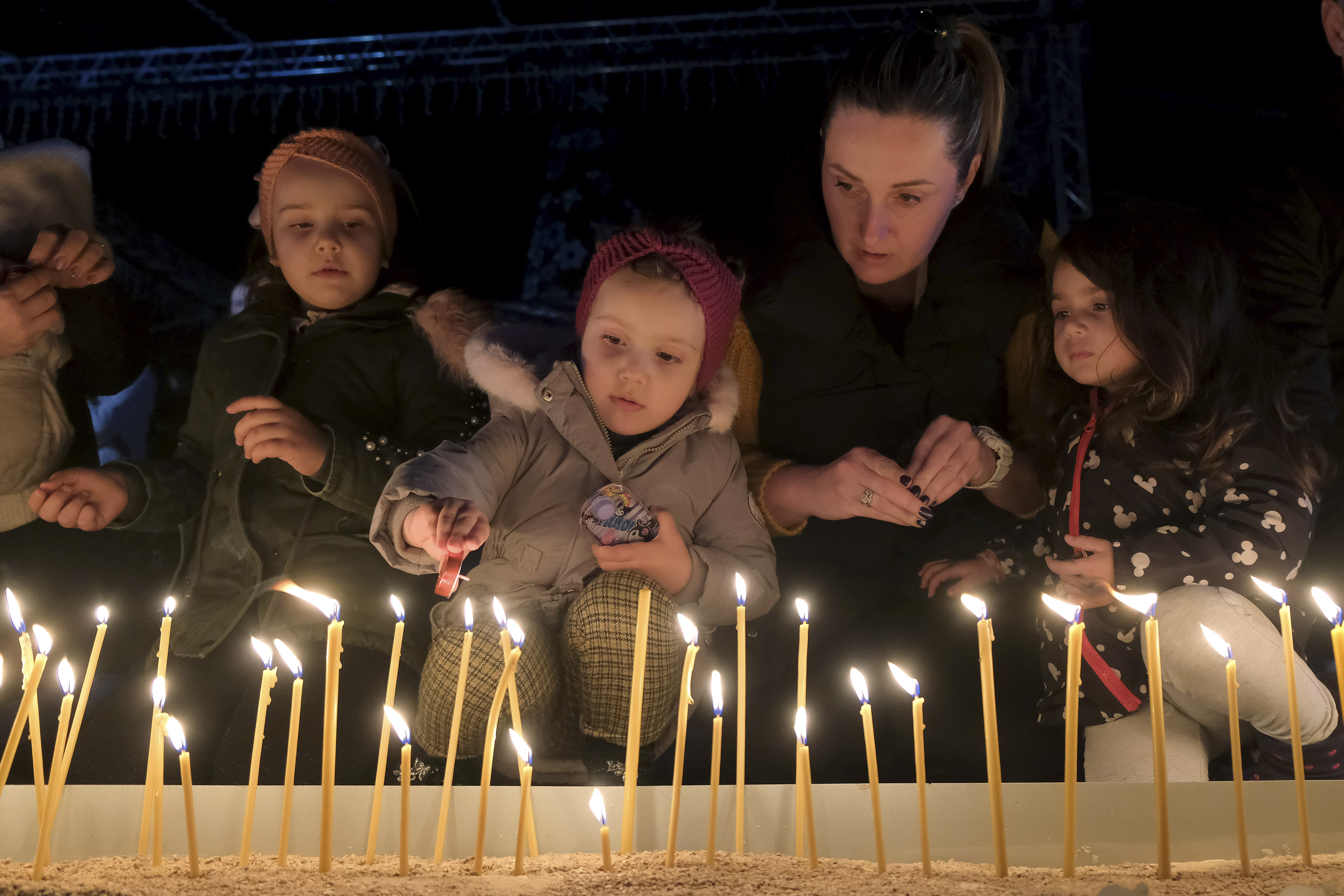 People light candles for the victims of the Wednesday's shooting rampage in Cetinje, in Podogrica, Montenegro, Thursday, Jan. 2, 2025. (AP Photo/Risto Bozovic)