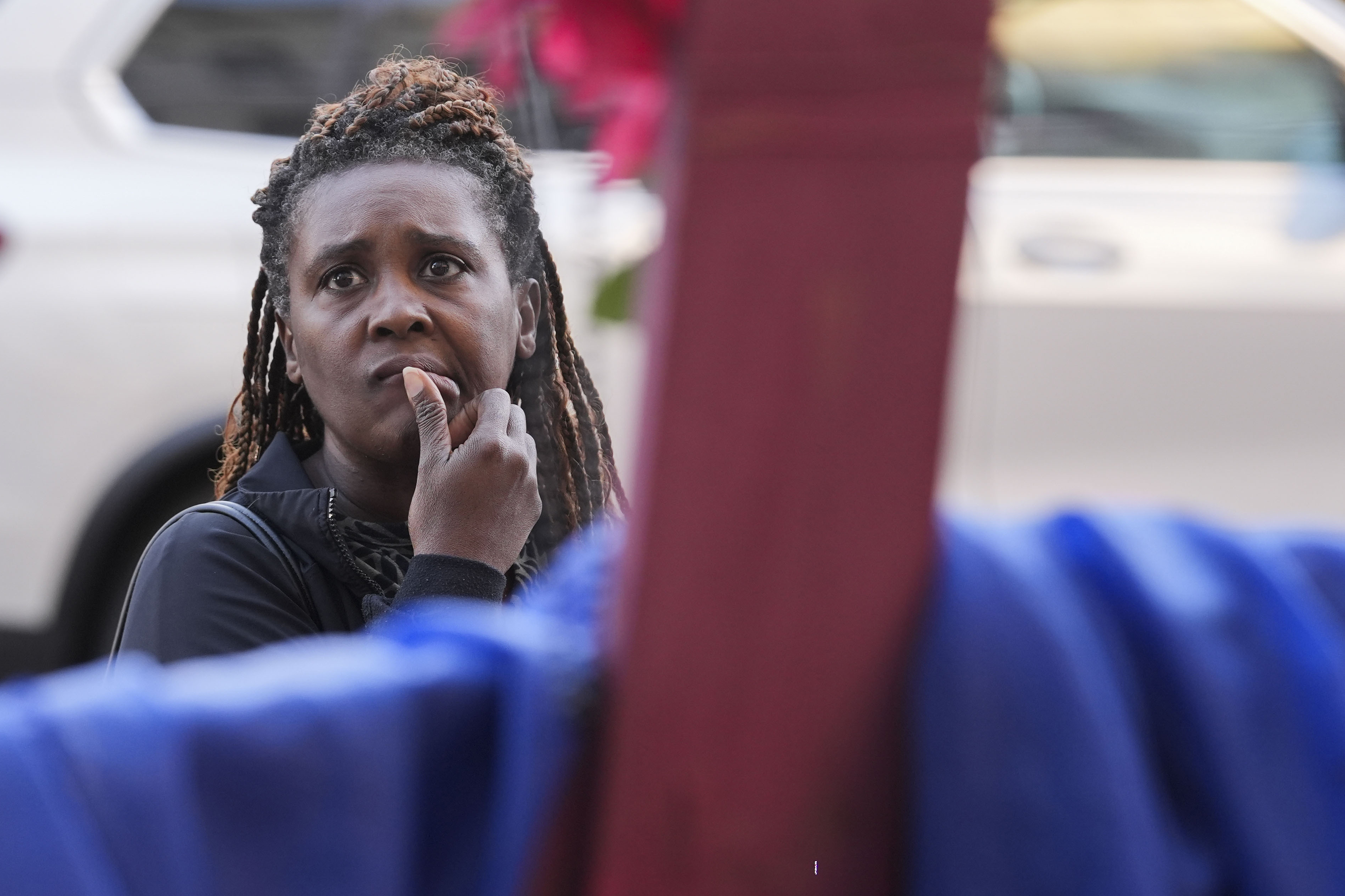 Katriel Faith Gibson, who lives nearby, reacts as she visits a memorial on Canal Street for the victims of a deadly truck attack on New Year's Day in New Orleans, Friday, Jan. 3, 2025. (AP Photo/Gerald Herbert)