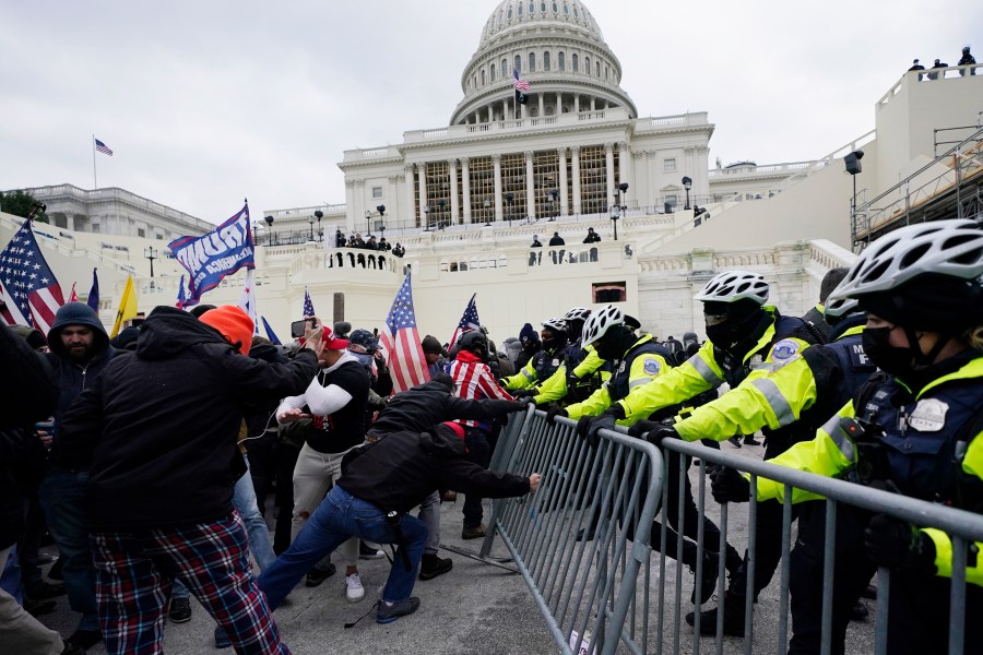 FILE - Insurrectionists loyal to President Donald Trump try to break through a police barrier, Wednesday, Jan. 6, 2021, at the Capitol in Washington. (AP Photo/Julio Cortez, File)