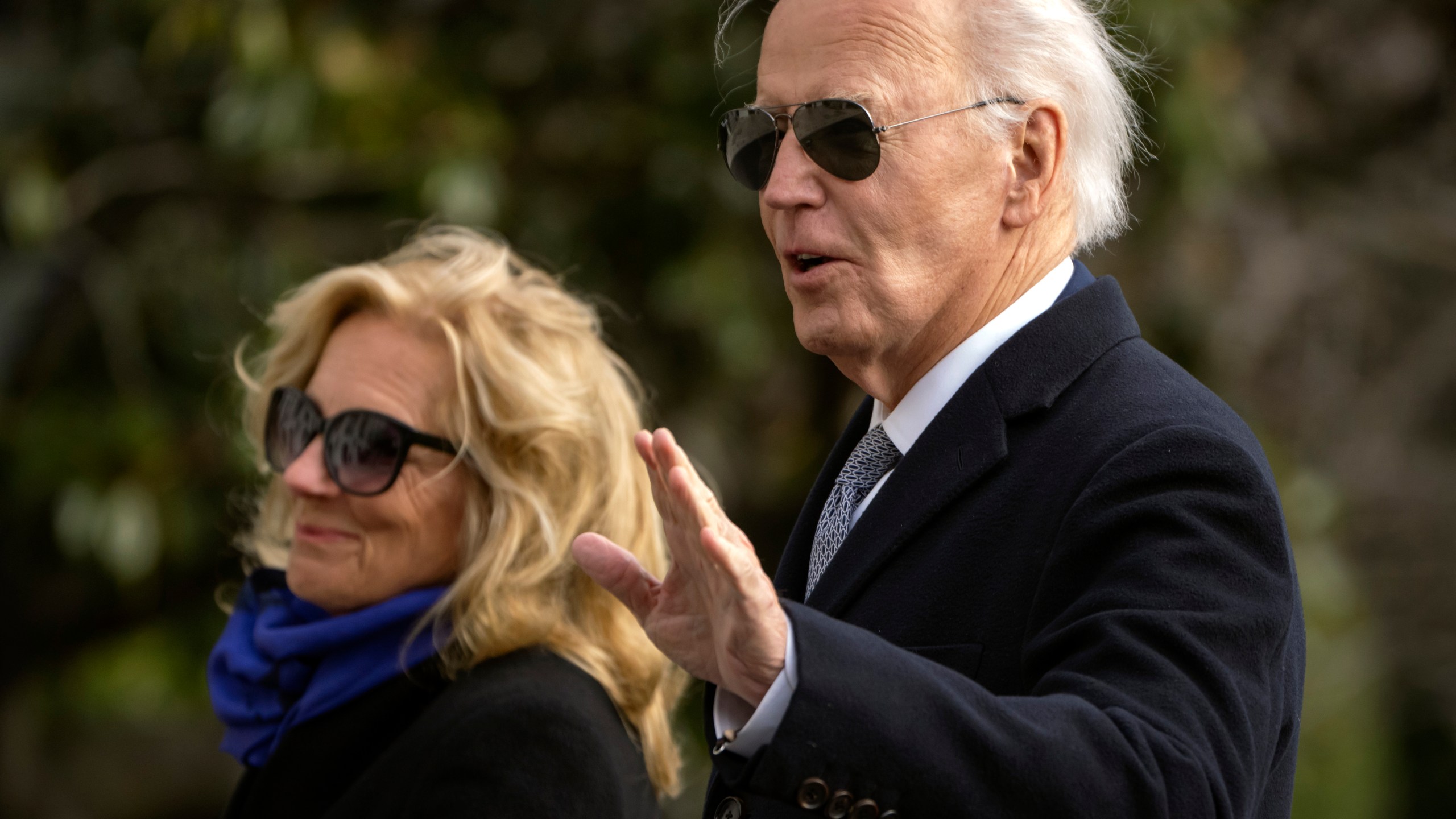 President Joe Biden gestures as he and first lady Jill Biden walk across the South Lawn of the White House, Thursday, Jan. 2, 2025, in Washington, after returning from Camp David. (AP Photo/Mark Schiefelbein)