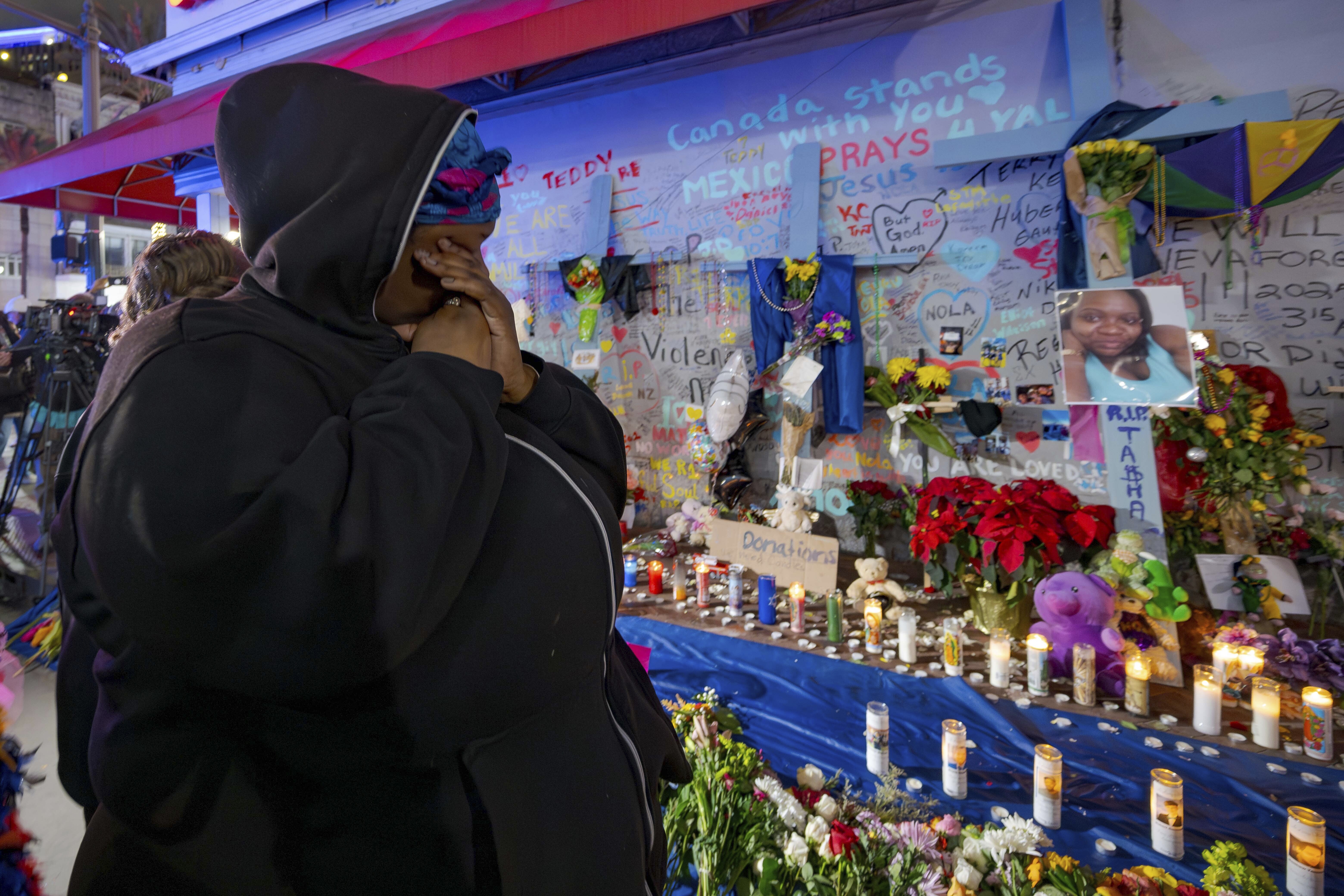 Courtney Polk, cousin of Tasha Polk, who was killed in the New Year's Day attack, reacts at a memorial on Bourbon Street and Canal Street in New Orleans, Saturday, Jan. 4, 2025, (AP Photo/Matthew Hinton)