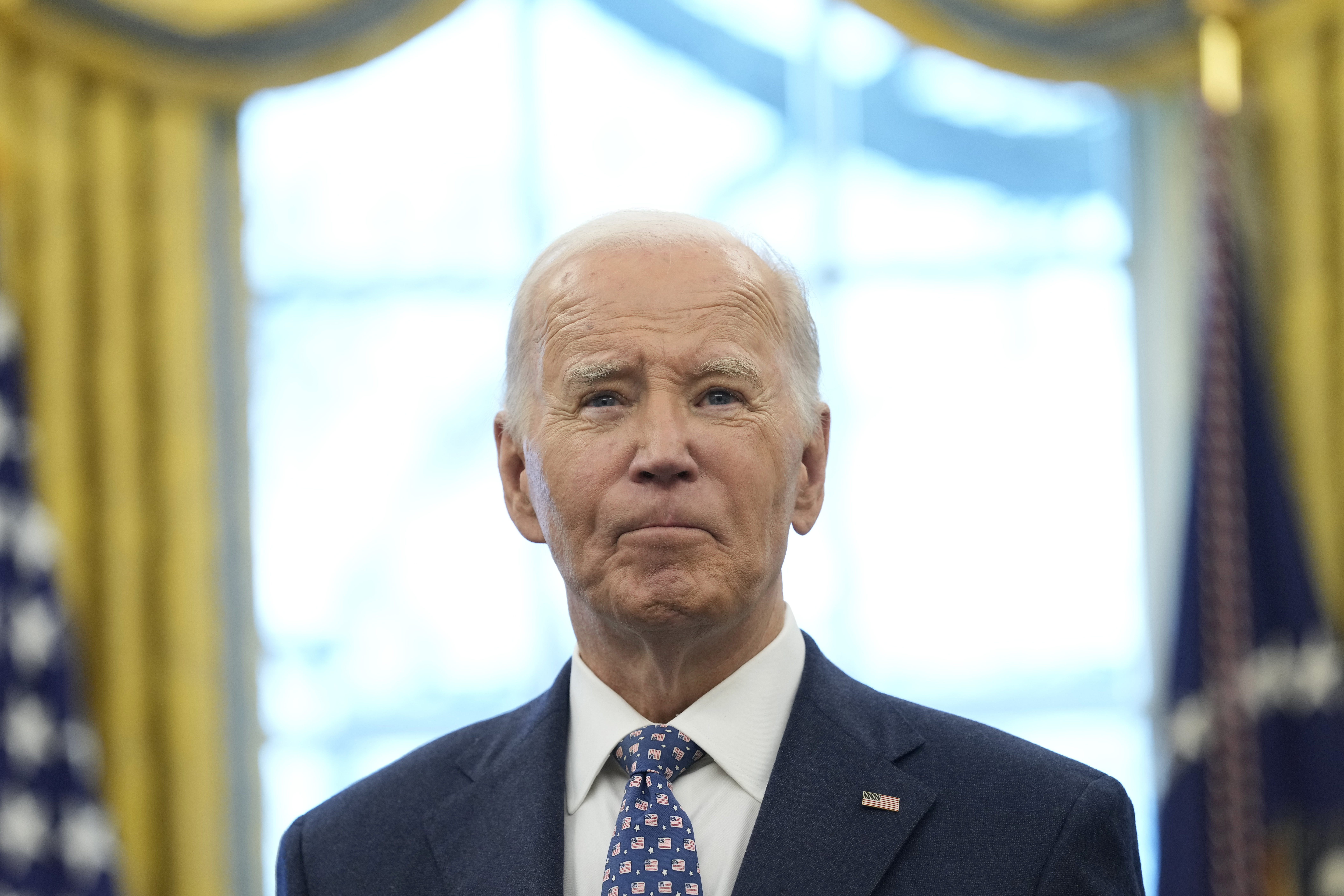 President Joe Biden pauses during a photo opportunity with Medal of Valor recipients in the Oval Office of the White House in Washington, Friday, Jan. 3, 2025. (AP Photo/Susan Walsh)