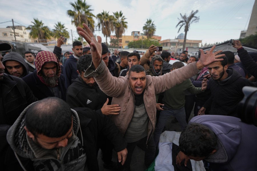 Palestinians mourn their relatives killed in the Israeli bombardment of the Gaza Strip, at Al-Aqsa Martyrs Hospital in Deir al-Balah, Sunday, Jan. 5, 2025. (AP Photo/Abdel Kareem Hana)