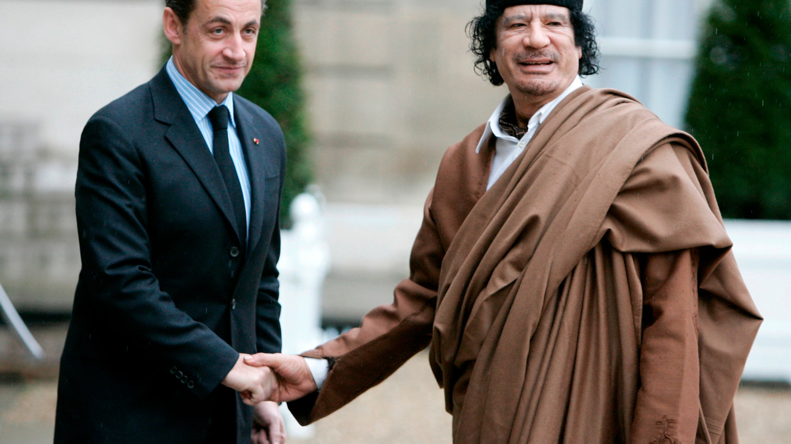 FILE - French President Nicolas Sarkozy, left, greets Libyan leader Col. Moammar Gadhafi upon his arrival at the Elysee Palace, Dec. 10 2007 in Paris. France's former President Nicolas Sarkozy goes on trial Monday Jan.6, 2025 over alleged illegal financing of his 2007 presidential campaign by the government of late Libyan leader Moammar Gadhafi. (AP Photo/Francois Mori, File)