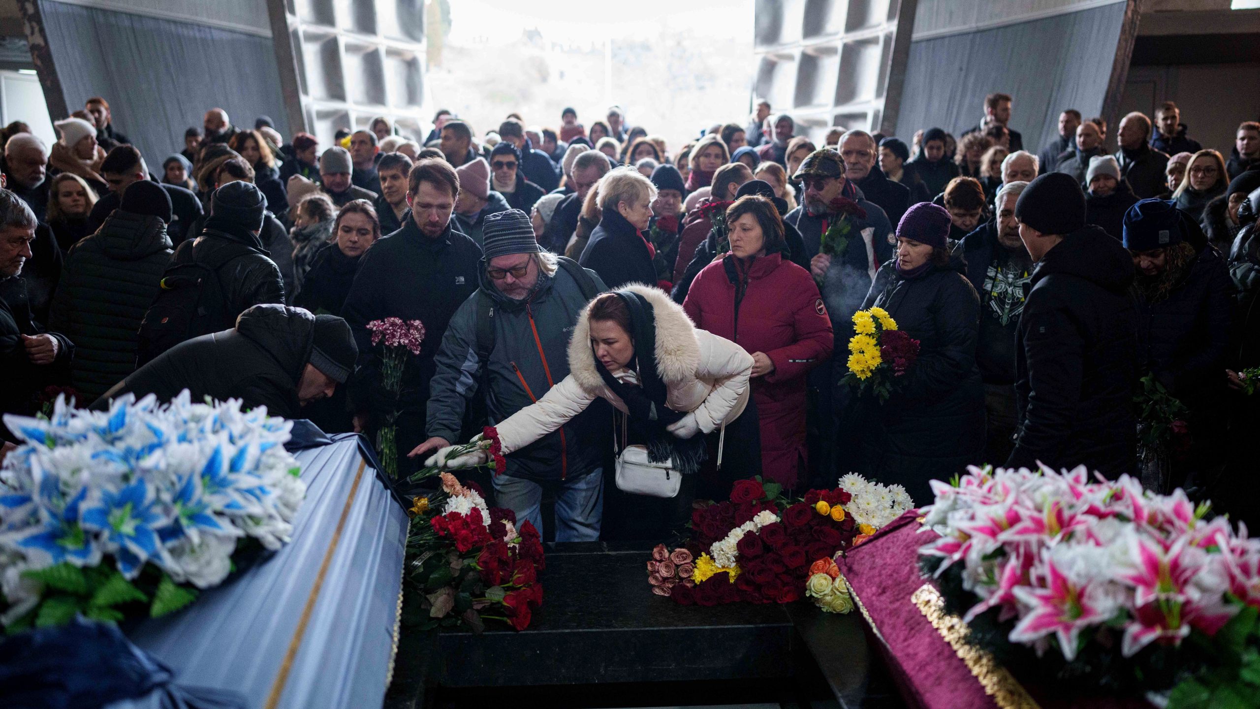 People attend the funeral ceremony of neurobiologist Ihor Zyma and his wife, biologist Olesia Sokur, who were killed by a Russian strike on Jan. 1, in Kyiv Monday, Jan. 6, 2025. (AP Photo/Evgeniy Maloletka)