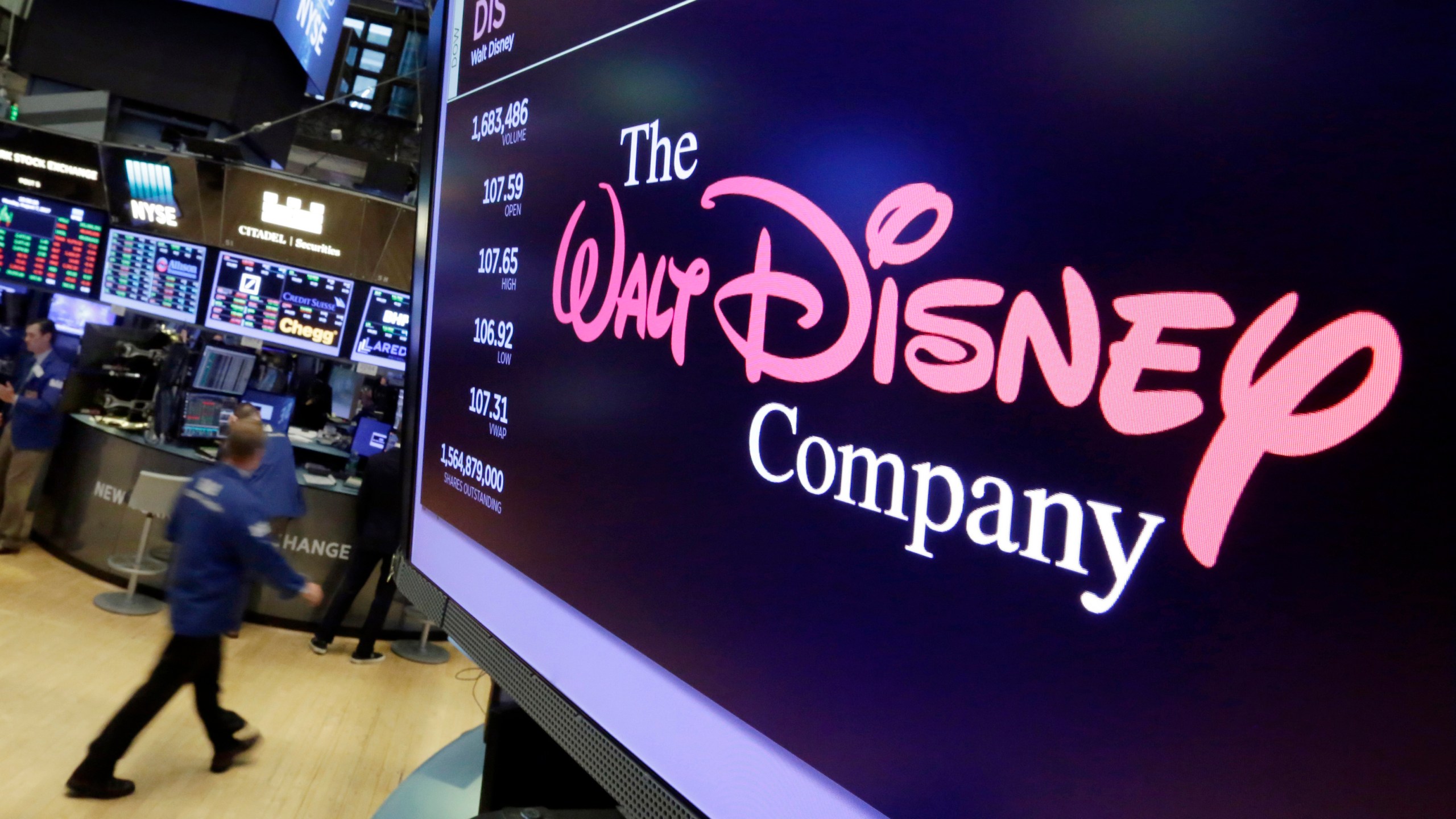 FILE - The Walt Disney Co. logo appears on a screen above the floor of the New York Stock Exchange, Aug. 8, 2017. (AP Photo/Richard Drew, File)