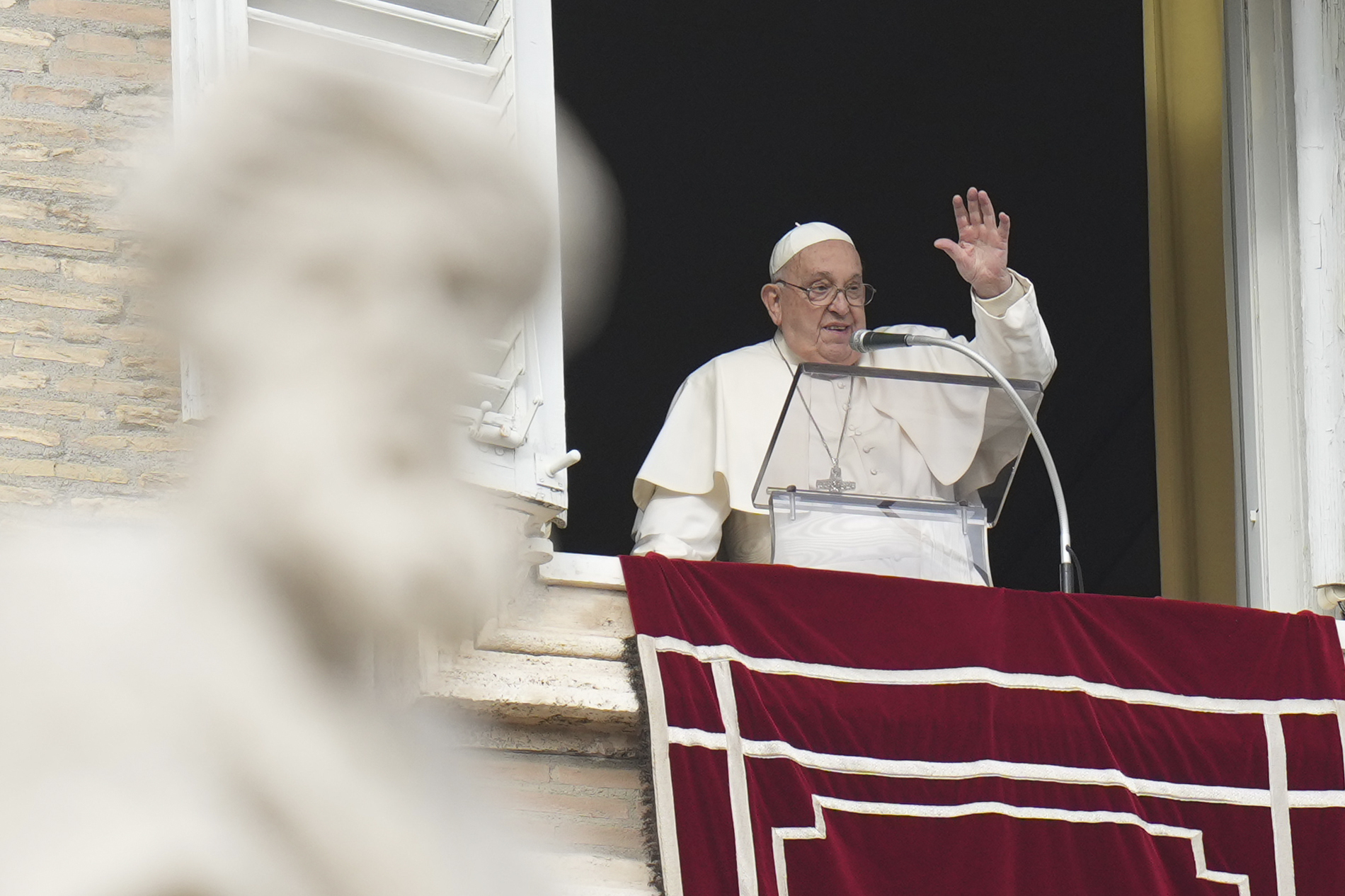 Pope Francis waves during the Angelus noon prayer on the occasion of the Epiphany day from the window of his studio overlooking St.Peter's Square, at the Vatican, Monday, Jan. 6, 2025. (AP Photo/Alessandra Tarantino)