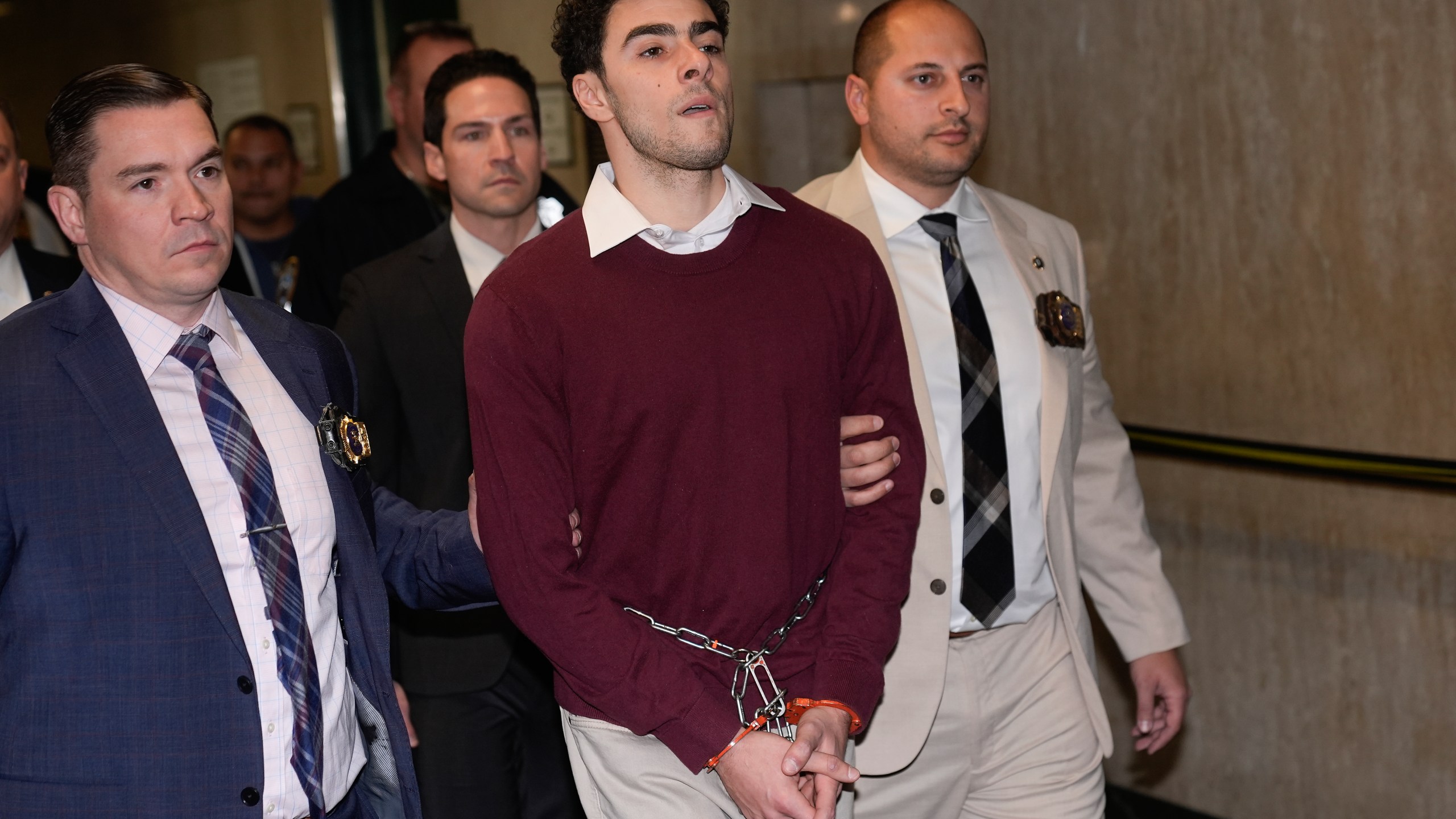 Luigi Mangione is escorted into Manhattan Criminal court for his arraignment on state murder and terror charges in the killing of UnitedHealthcare CEO Brian Thompson, Monday, Dec. 23, 2024, in New York. (AP Photo/Seth Wenig)