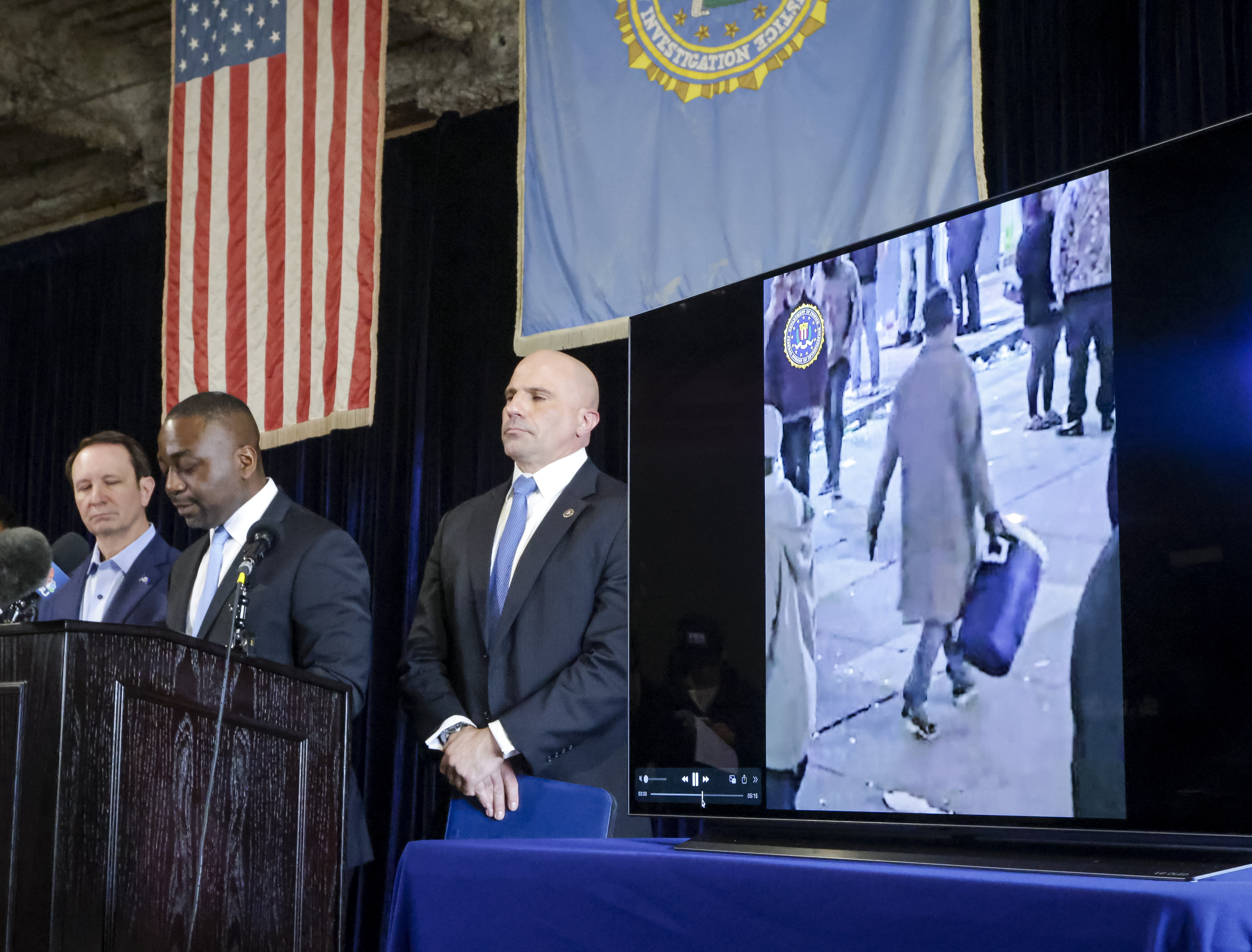 Lyonel Myrthil, special agent in charge of the New Orleans field office, second from left, shows footage of Shamsud-Din Jabbar, the man who carried out an attack on New Orleans' Bourbon Street on New Year's Day, during a news conference in a secure garage at the FBI Headquarters in New Orleans, Sunday, Jan. 5, 2025. (Scott Threlkeld/The Times-Picayune/The New Orleans Advocate via AP)