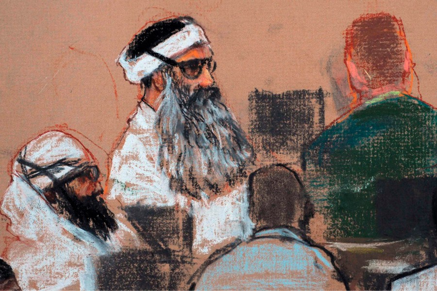 FILE - This Monday, Dec. 8, 2008 courtroom drawing by artist Janet Hamlin and reviewed by the U.S. military, shows Khalid Sheikh Mohammed, center, and co-defendant Walid Bin Attash, left, attending a pre-trial session at Guantanamo Bay Naval Base, Cuba. (AP Photo/Janet Hamlin, Pool, File)