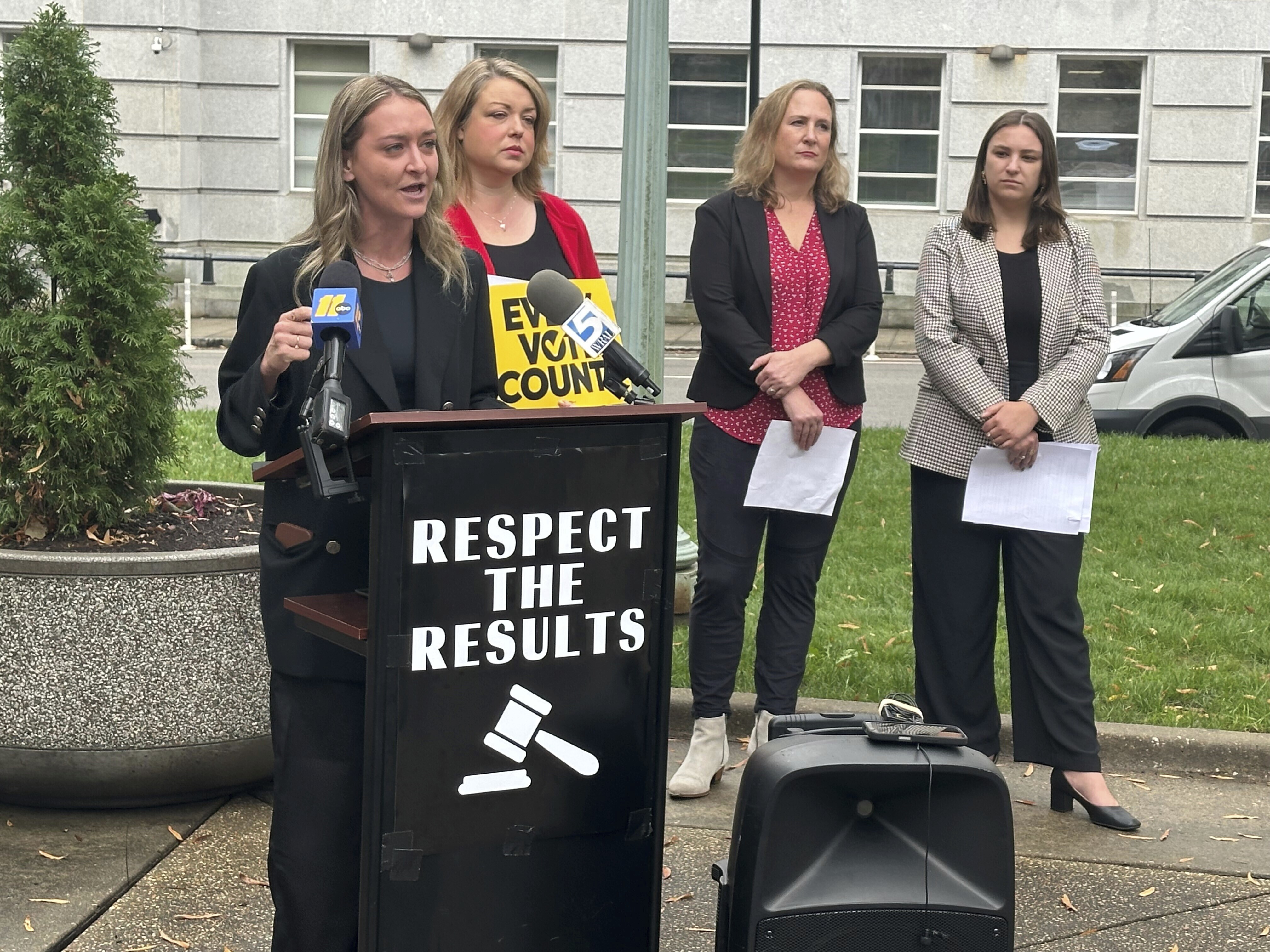 North Carolina state Democratic Party Chair Anderson Clayton, left, speaks at a news conference about the pending election for a state Supreme Court seat on Tuesday, Dec. 10, 2024, on Capitol Square in Raleigh, N.C. (AP Photo/Gary D. Robertson)