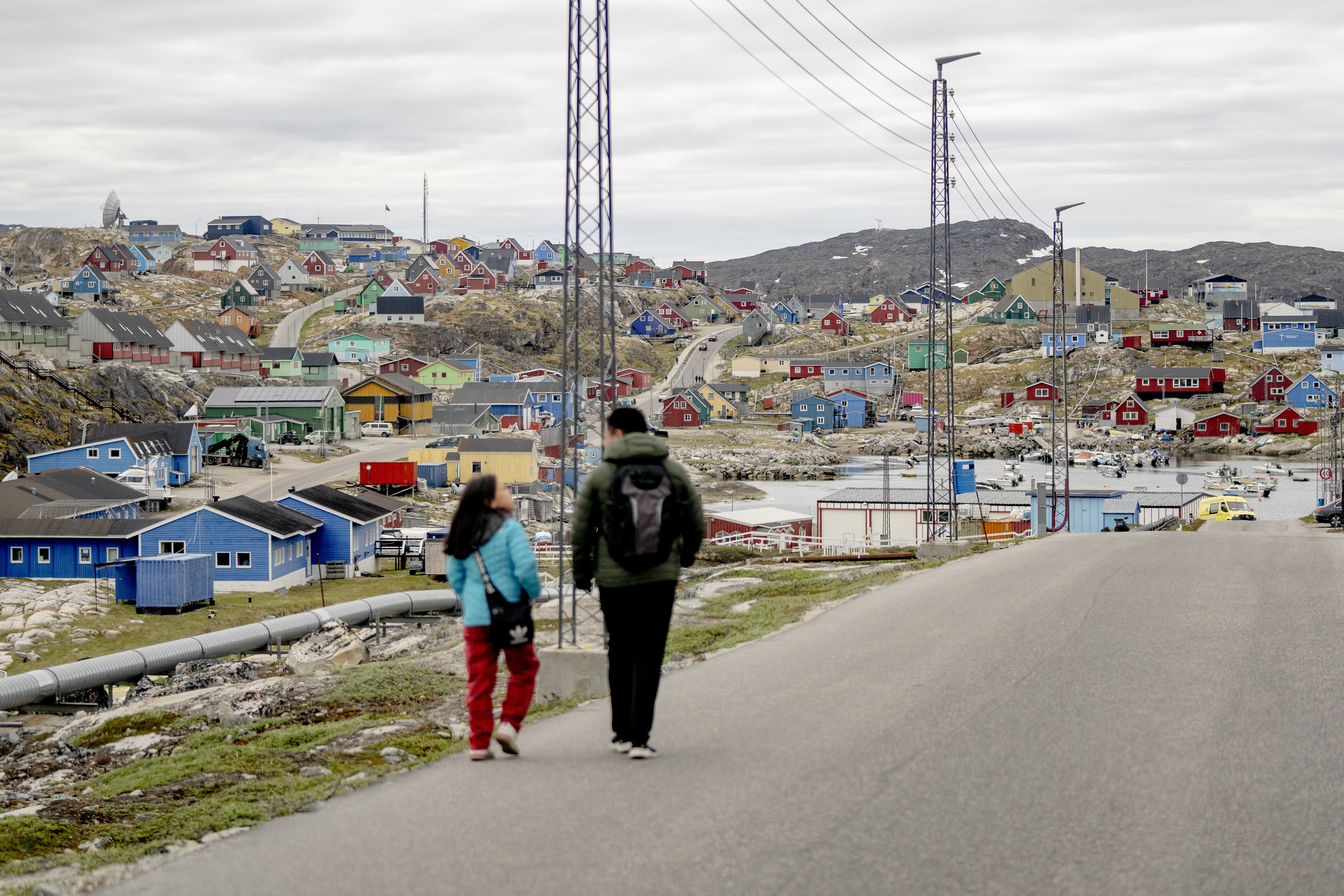 FILE - People walk in the town of Aasiaat, in western Greenland, located on its namesake island in the heart of Aasiaat Archipelago at the southern end of Disko Bay, in Greenland, Saturday, June 29, 2024. (Ida Marie Odgaard/Ritzau Scanpix via AP, File)