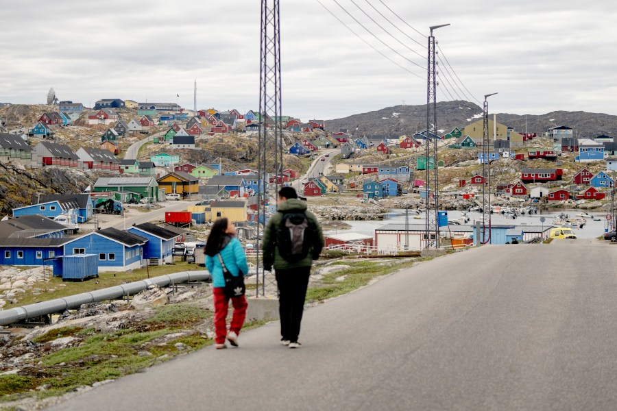 FILE - People walk in the town of Aasiaat, in western Greenland, located on its namesake island in the heart of Aasiaat Archipelago at the southern end of Disko Bay, in Greenland, Saturday, June 29, 2024. (Ida Marie Odgaard/Ritzau Scanpix via AP, File)