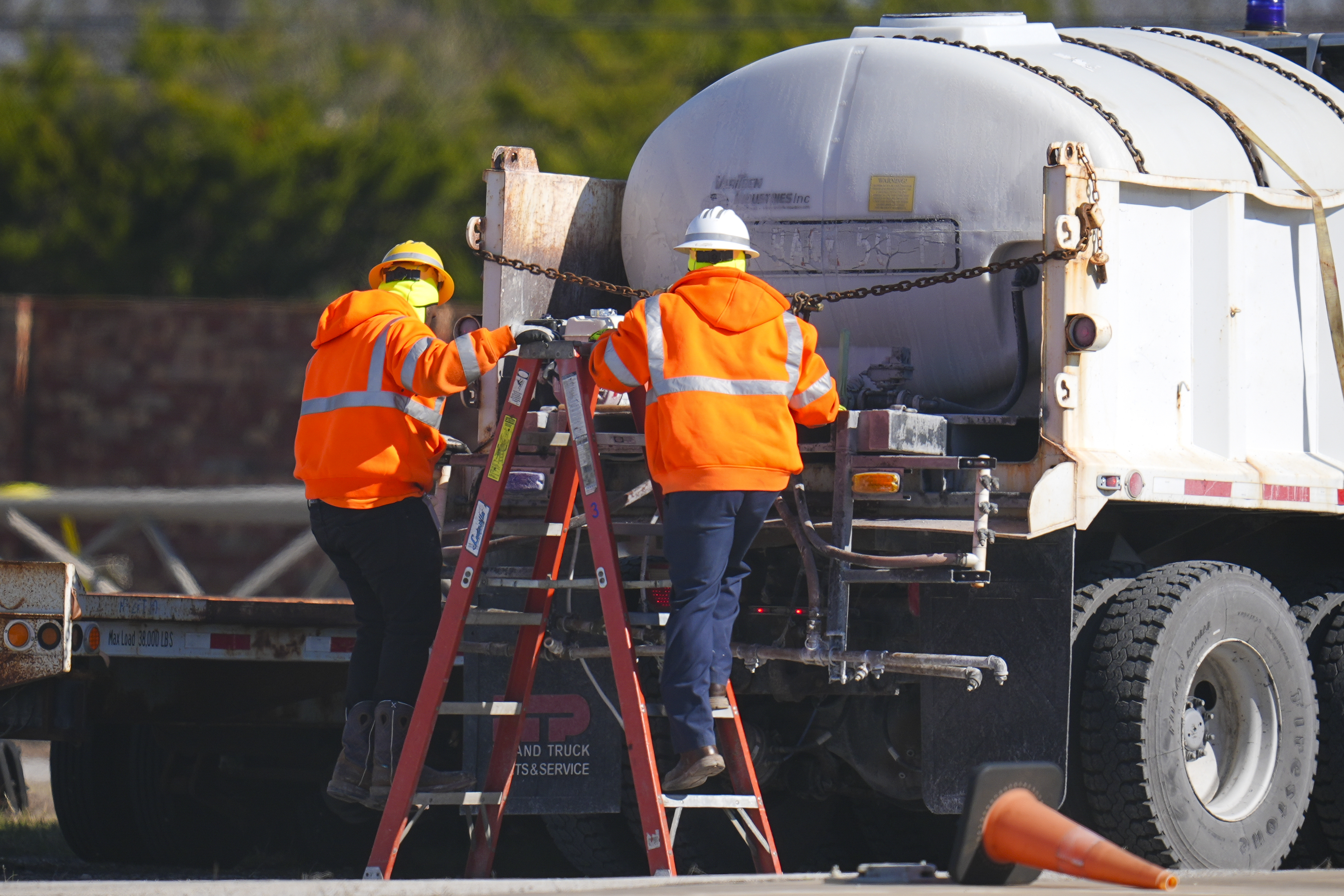 Workers labor on a brine truck at the Texas Department of Transportation Dallas Southwest lot as crews prepare the roads ahead of a winter storm expected to hit the North Texas region, Tuesday, Jan. 7, 2025, in Cedar Hill, Texas. (AP Photo/Julio Cortez)