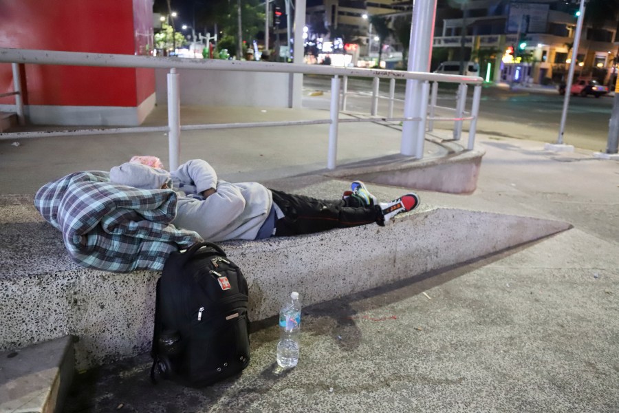 A migrant sleeps on the side of a street in Acapulco, Mexico, Monday, Jan. 6, 2025. (AP Photo/Bernardino Hernandez)