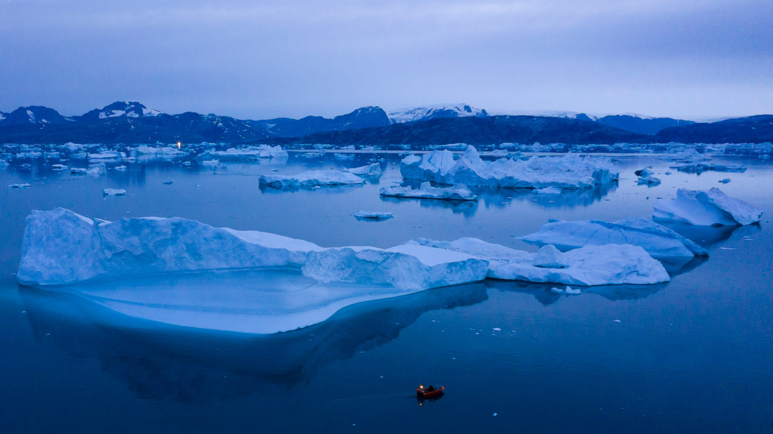 FILE - A boat navigates large icebergs near the town of Kulusuk, in eastern Greenland, on Aug. 15, 2019. (AP Photo/Felipe Dana, File)