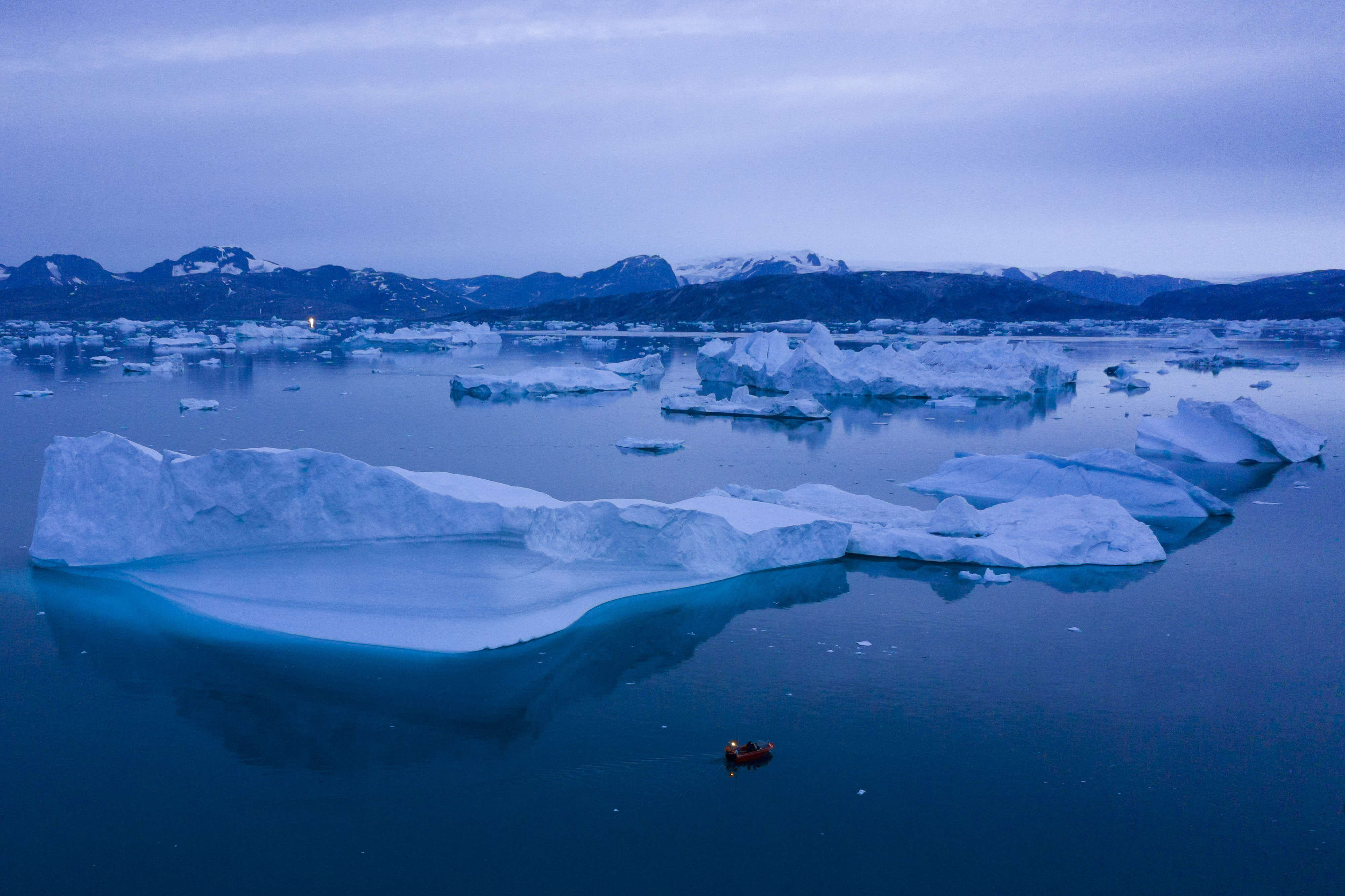 FILE - A boat navigates large icebergs near the town of Kulusuk, in eastern Greenland, on Aug. 15, 2019. (AP Photo/Felipe Dana, File)