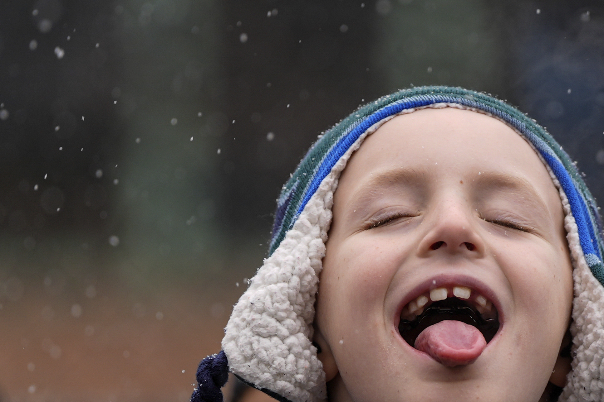 A child catches snowflakes with their tongue during El Museo del Barrio's 47th annual Three Kings Day parade, Monday, Jan. 6, 2025, in New York. (AP Photo/Julia Demaree Nikhinson)