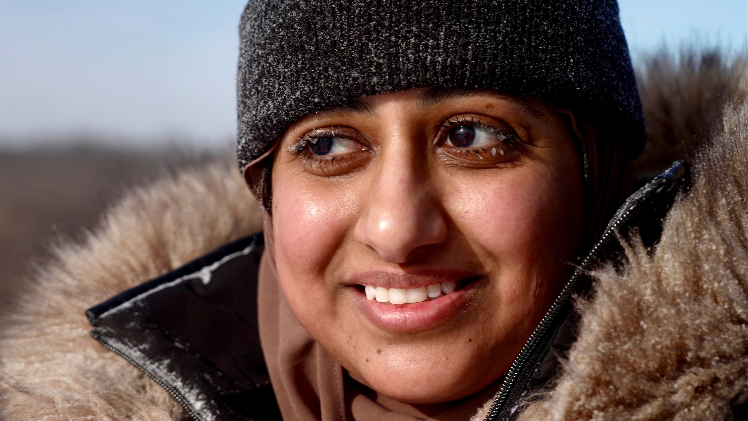 Ruqayah Nasser takes a break after her first snow tubing runs in below-zero cold during an outing organized by a Minnesota group promoting outdoors activities by Muslim women, at Elm Creek Park Reserve in Maple Grove, Minn., on Jan. 4, 2025. (AP Photo/Mark Vancleave)