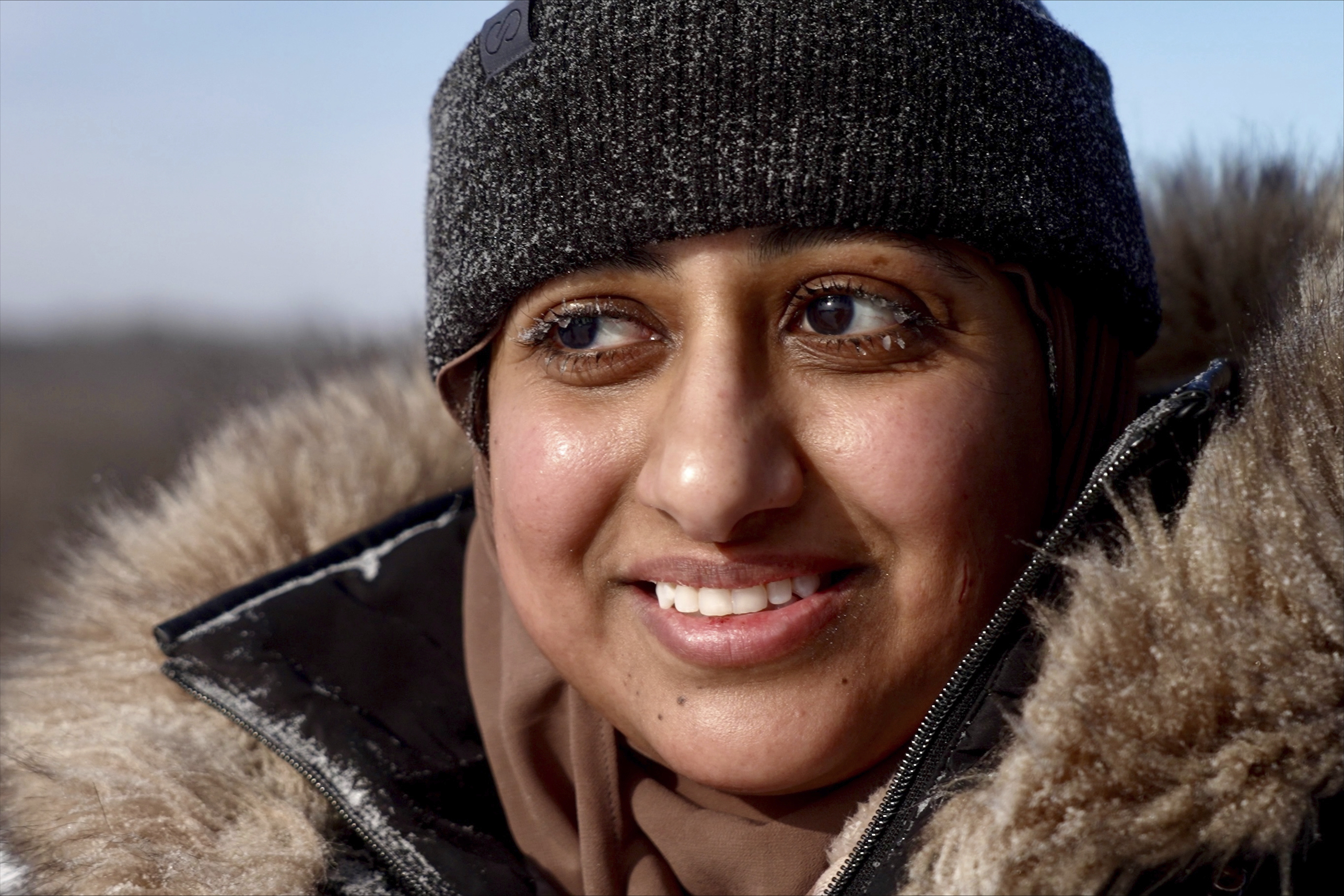 Ruqayah Nasser takes a break after her first snow tubing runs in below-zero cold during an outing organized by a Minnesota group promoting outdoors activities by Muslim women, at Elm Creek Park Reserve in Maple Grove, Minn., on Jan. 4, 2025. (AP Photo/Mark Vancleave)