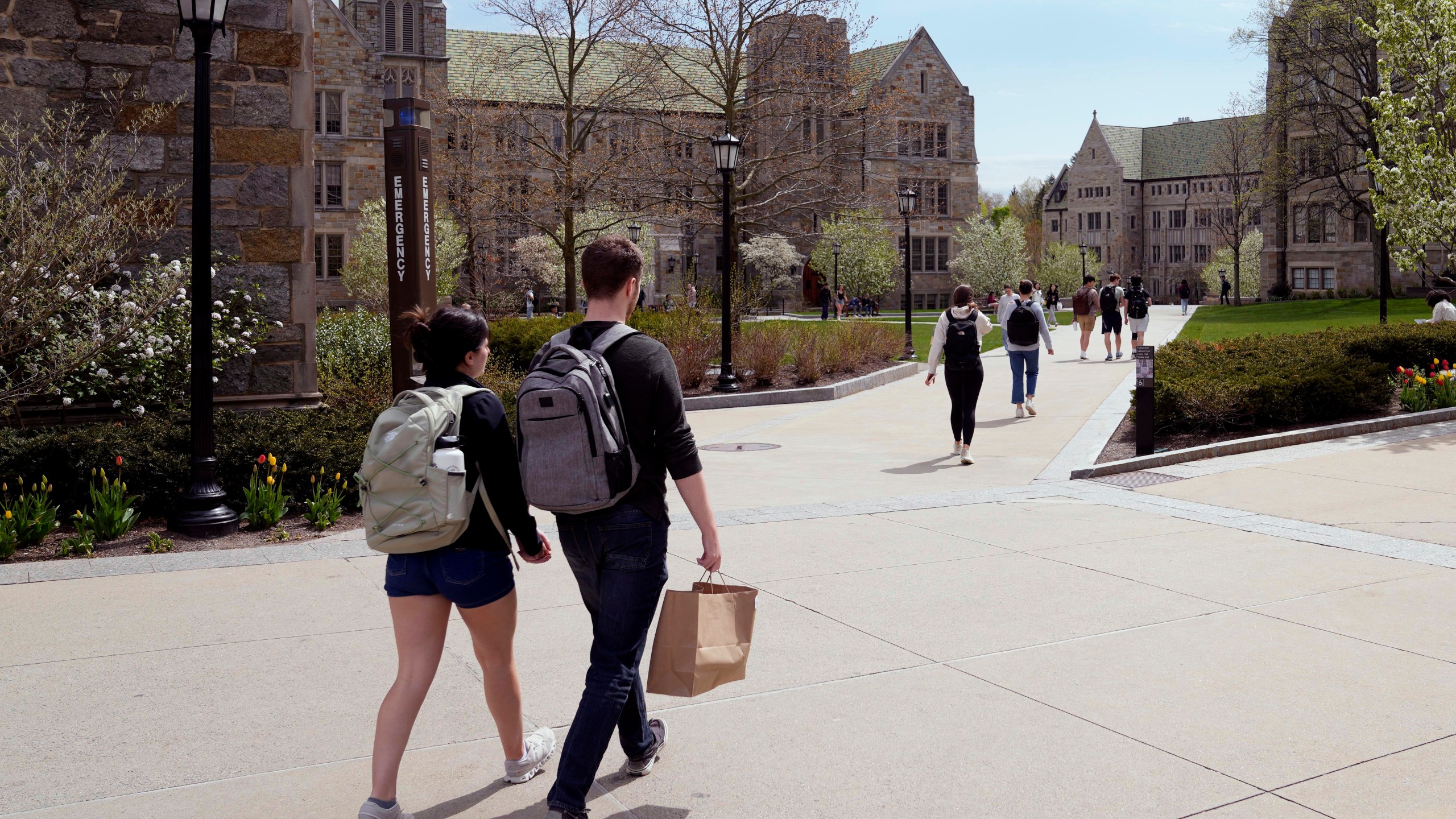 FILE - Students walk on the campus of Boston College, Monday, April 29, 2024, in Boston. . (AP Photo/Charles Krupa, File)