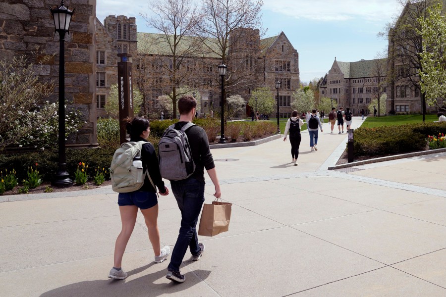 FILE - Students walk on the campus of Boston College, Monday, April 29, 2024, in Boston. . (AP Photo/Charles Krupa, File)