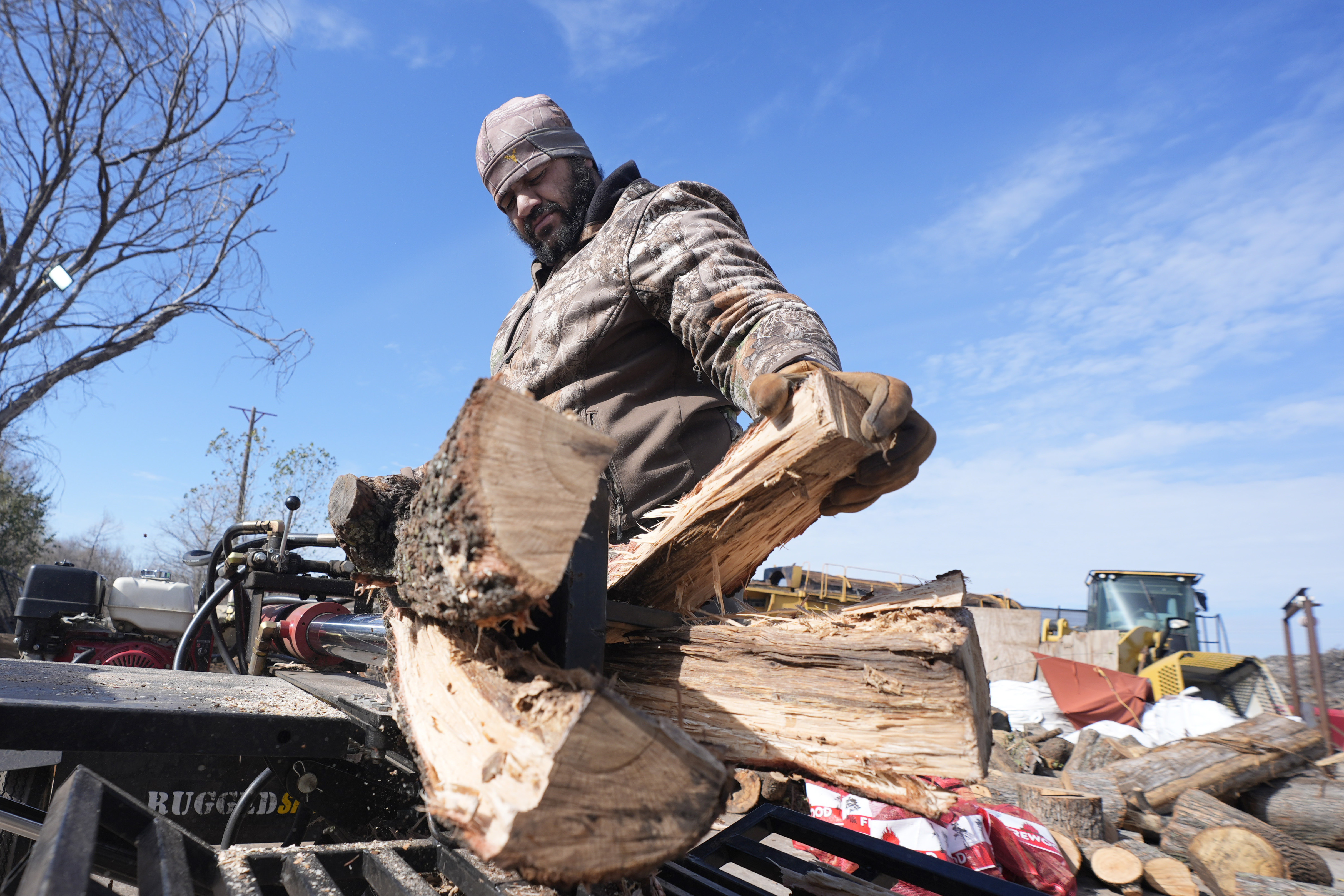 Sterling Howard splits logs for firewood ahead of a winter storm expected to hit the North Texas region later tomorrow Wednesday, Jan. 8, 2025, in Dallas. (AP Photo/LM Otero)