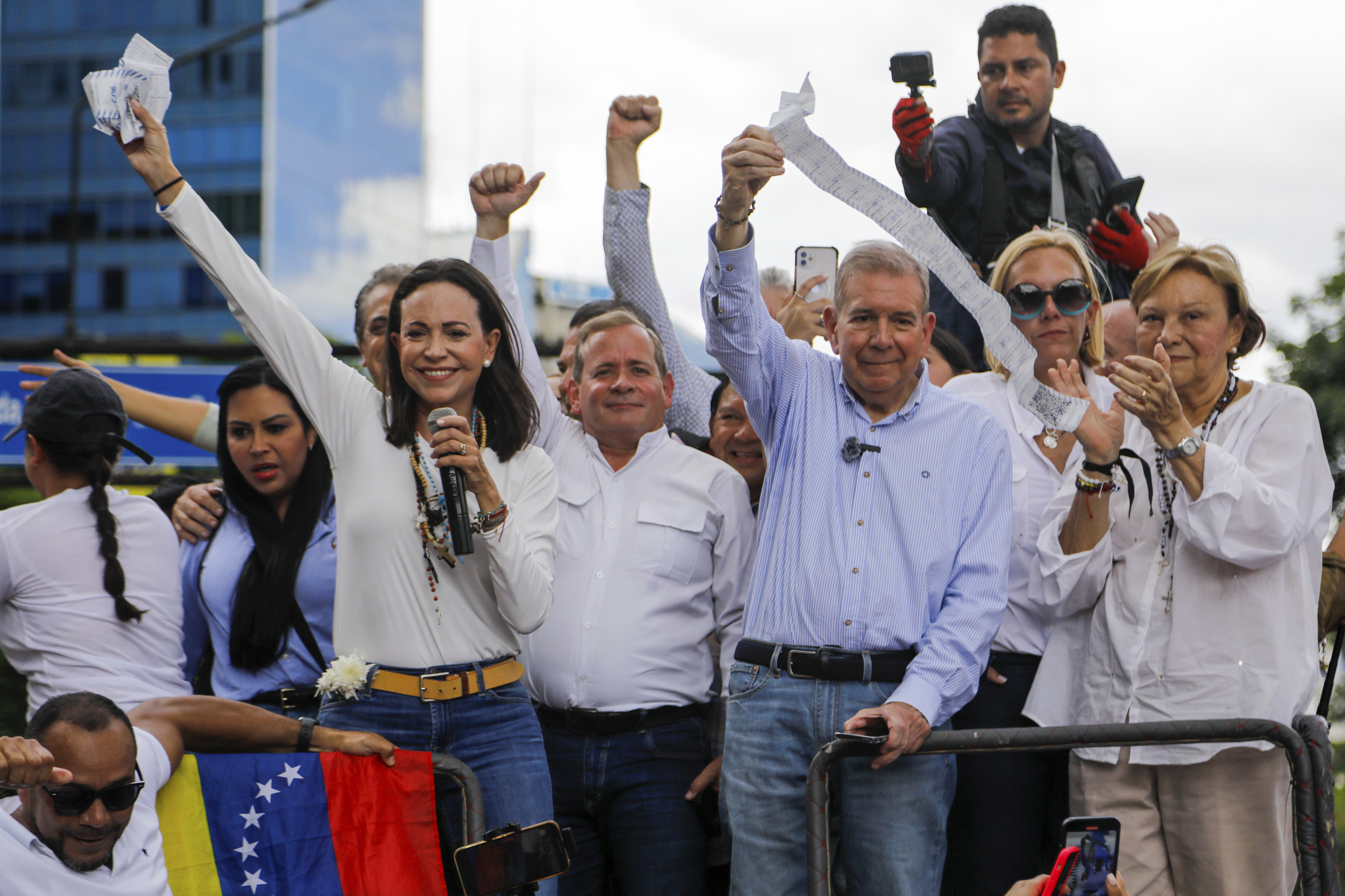 FILE - Opposition leader Maria Corina Machado, left, and opposition candidate Edmundo Gonzalez hold up vote tally sheets from the top of a truck during a protest against the official presidential election results declaring President Nicolas Maduro the winner in Caracas, Venezuela, July 30, 2024, two days after the election. (AP Photo/Cristian Hernandez, File)