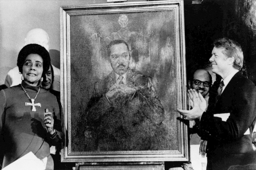 FILE - Coretta Scott King, widow of slain civil rights leader Martin Luther King Jr., speaks at an unveiling of a portrait of Martin Luther King by artist George Mandus on Feb. 18, 1974, while Gov. Jimmy Carter, right, looks on. (AP Photo/File)