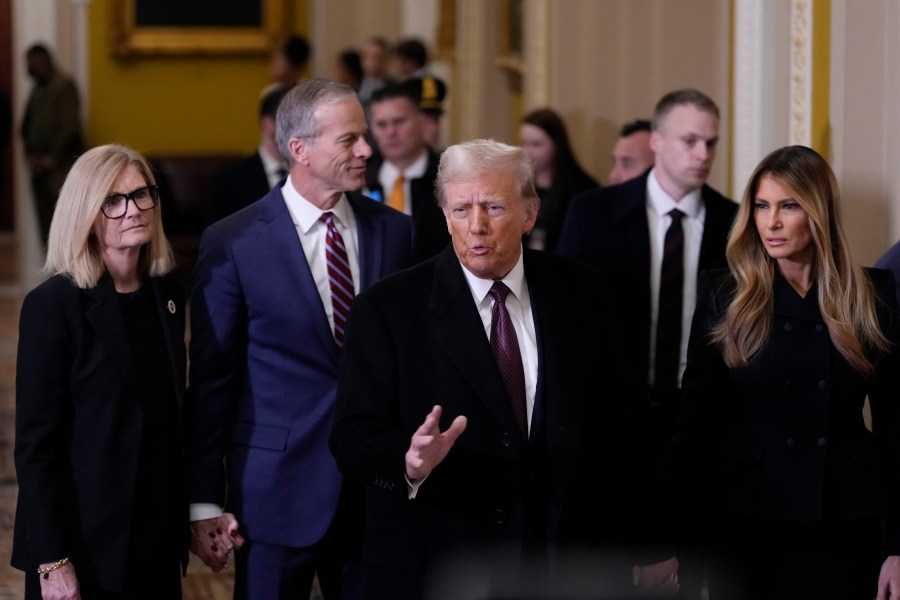 President-elect Donald Trump, center, and his wife Melania, walk with Majority Leader John Thune, R-S.D., and his wife, Kimberley, to meet with Senate Republican at the U.S. Capitol, Wednesday, Jan. 8, 2025, in Washington. (AP Photo/Steve Helber)