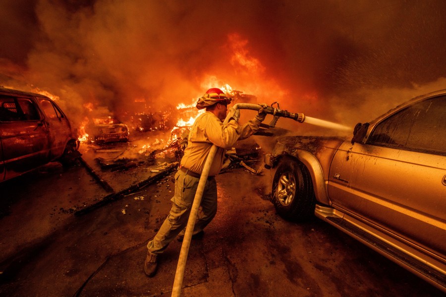 A firefighter battles the Eaton Fire Wednesday, Jan. 8, 2025 in Altadena, Calif. (AP Photo/Ethan Swope)