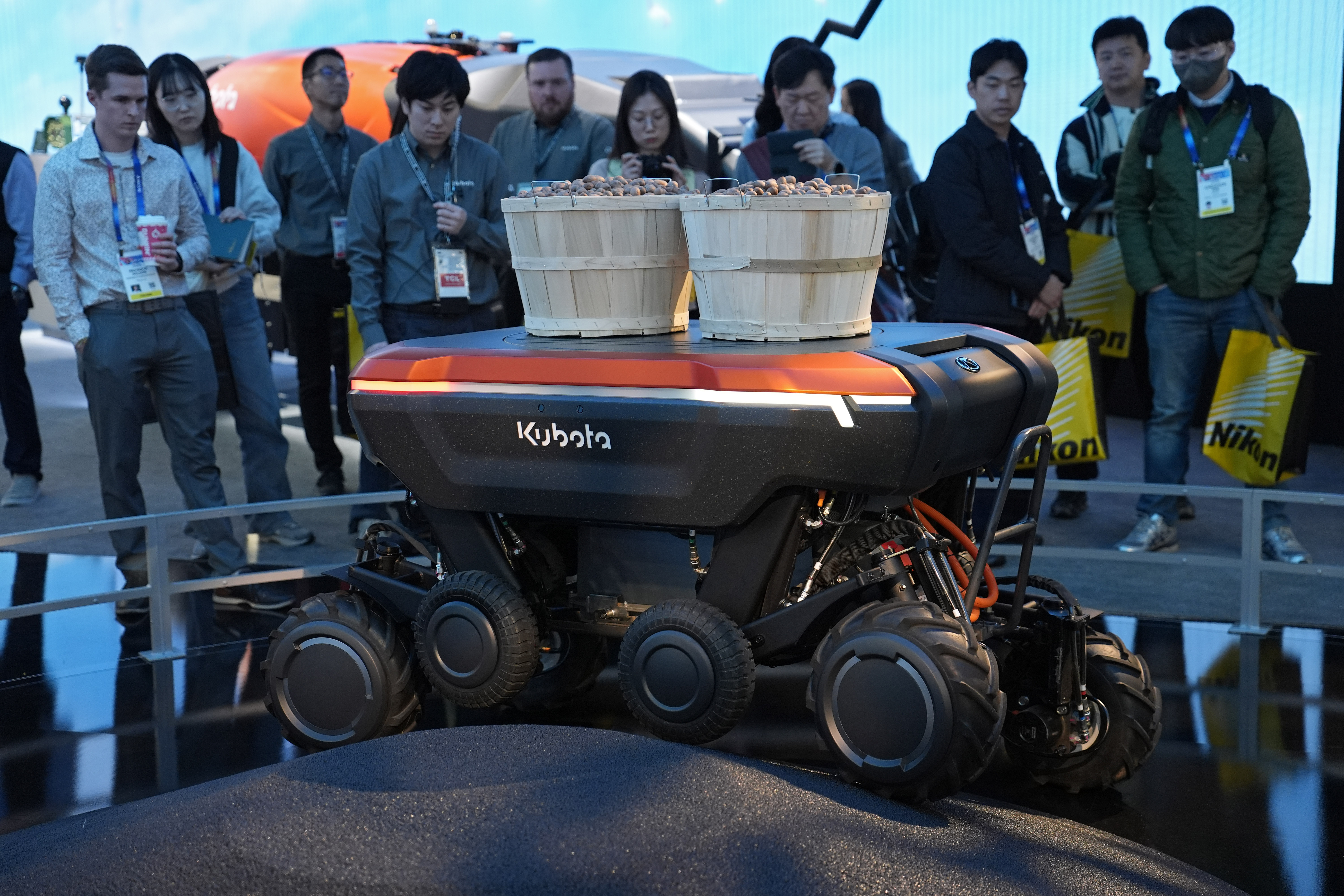 People view a demonstration of the KATR robot designed to work in agriculture and construction at the Kubota booth during the CES tech show Tuesday, Jan. 7, 2025, in Las Vegas. (AP Photo/John Locher)