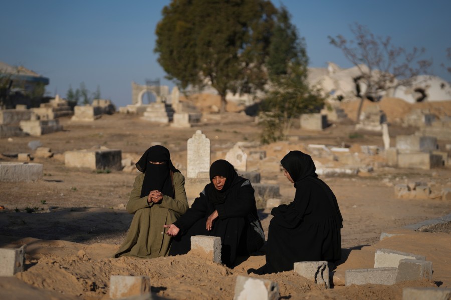 Fatma Abu Awad and her daughter Malak pray in a graveyard where their relatives who were killed by an Israeli airstrike are buried, in Khan Younis, Gaza, Thursday, Jan. 9, 2025. (AP Photo/Abdel Kareem Hana)