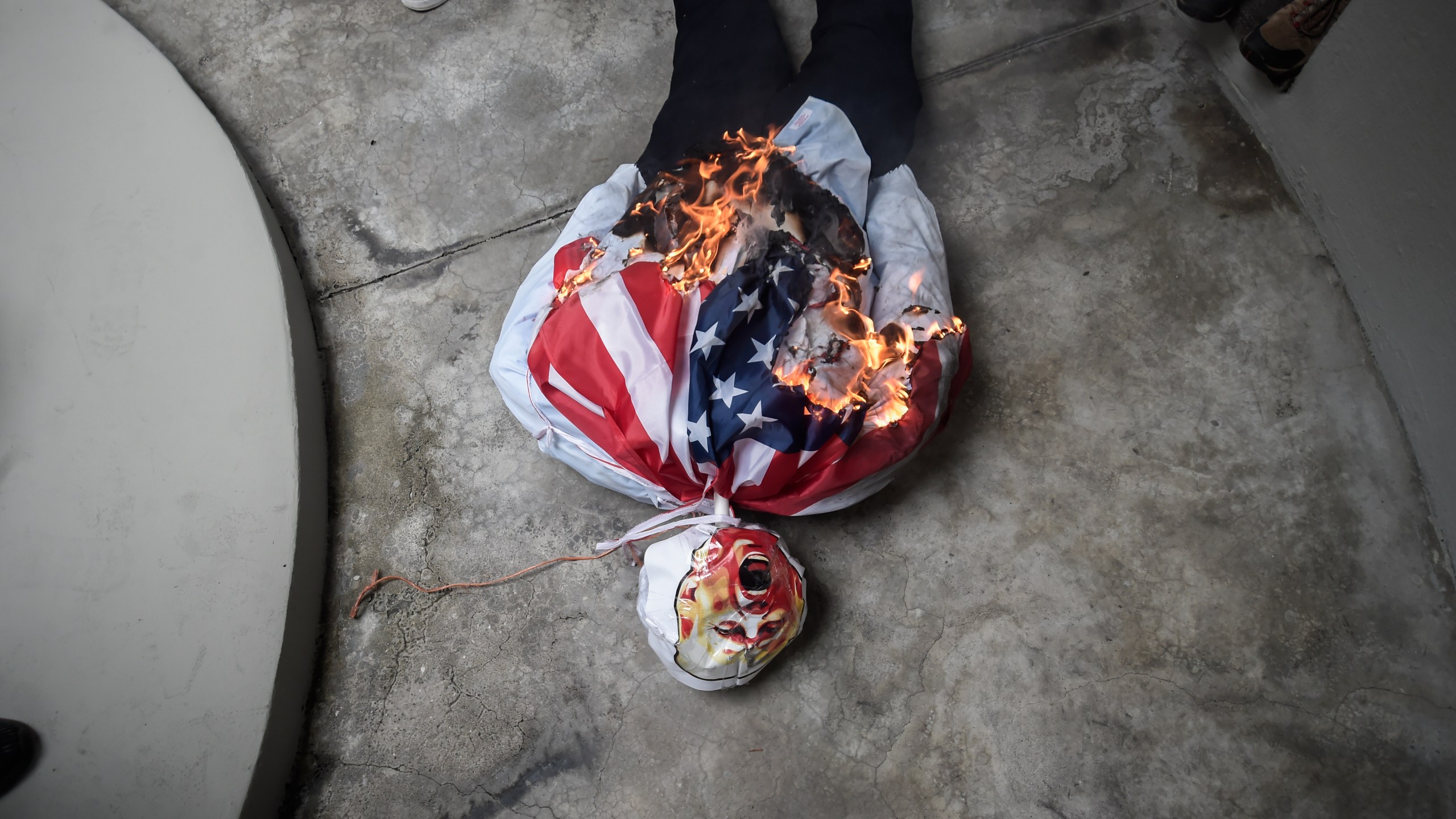 An effigy of President-elect Donald Trump is set on fire during a demonstration marking Martyrs' Day, a national day of mourning to honor the 21 Panamanians who were killed during the January 1964 anti-American riots over sovereignty of the Panama Canal Zone, in Panama City, Thursday, Jan. 9, 2025. (AP Photo/Agustin Herrera)