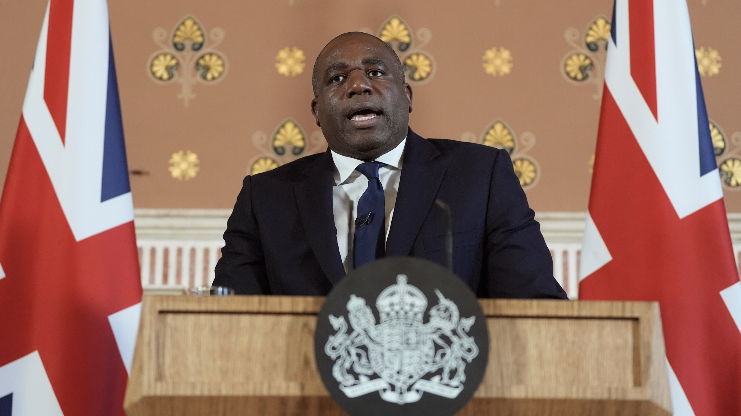 Britain's Foreign Secretary David Lammy delivers a speech on the government plans for new sanctions which will target the finances of people smuggling networks as part of efforts to stop migrants crossing the English Channel, in London, Thursday, Jan. 9, 2025. (Stefan Rousseau/Pool Photo via AP)