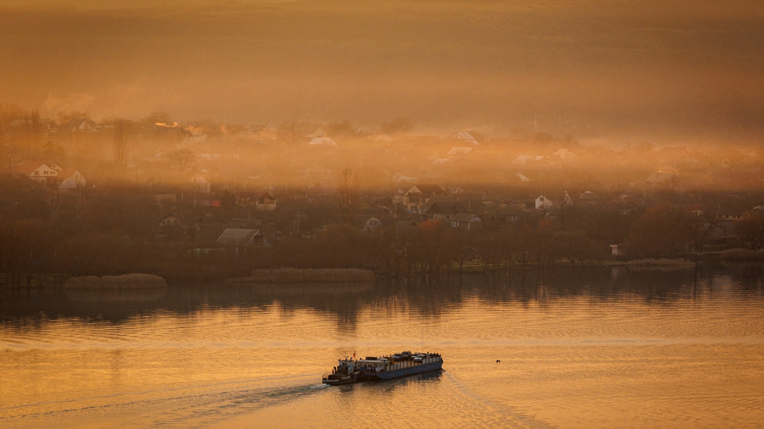 A ferry sails to the left bank of the Dniester river, the border between Moldova and Transnistria, seen from Molovata, Moldova, Wednesday, Jan. 8, 2025. (AP Photo)